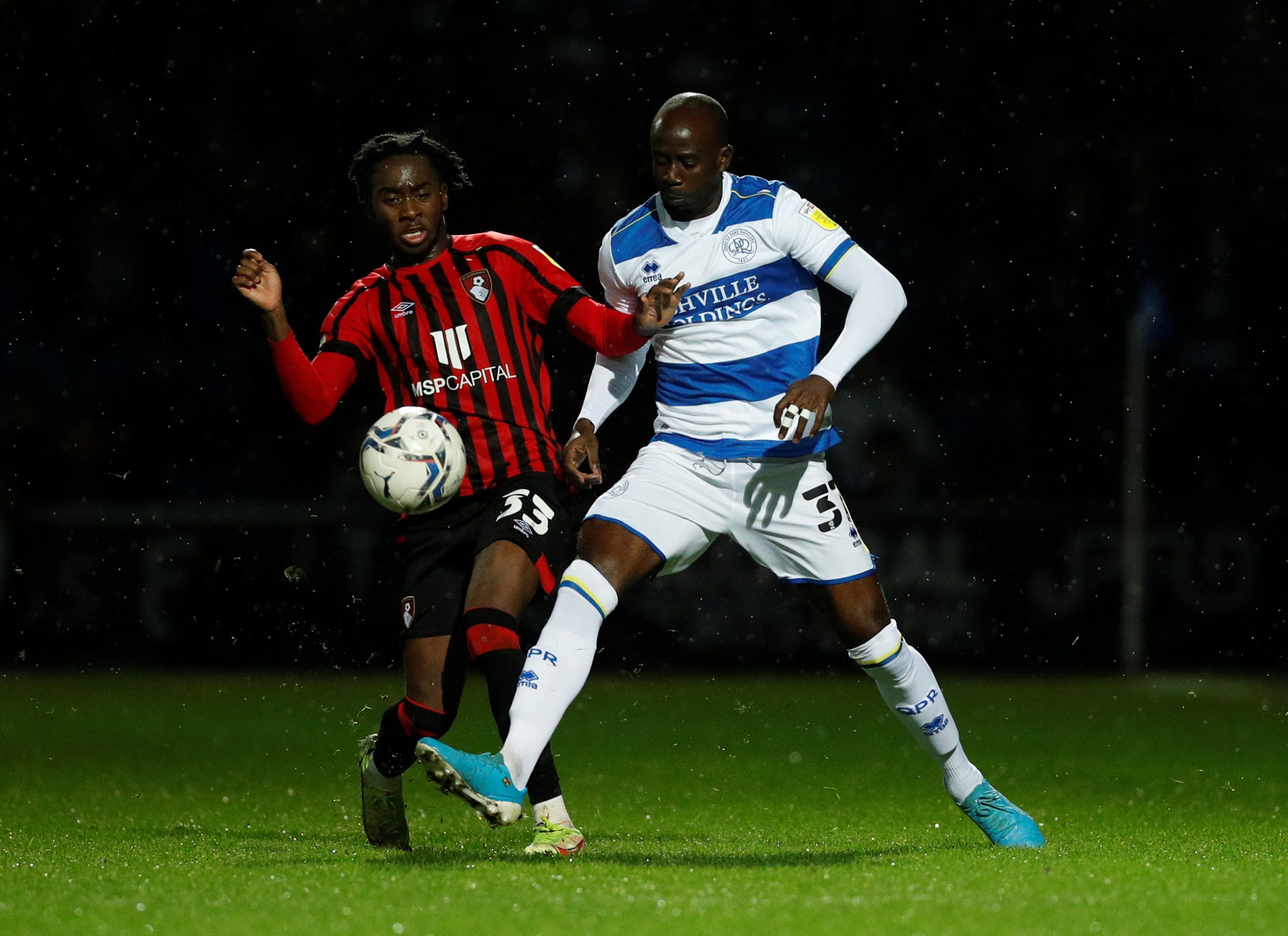 Soccer Football - Championship - Queens Park Rangers v AFC Bournemouth - Loftus Road, London, Britain - December 27, 2021 Queens Park Rangers' Albert Adomah in action with AFC Bournemouth's Jordan Zemura  Action Images/Andrew Boyers  EDITORIAL USE ONLY. No use with unauthorized audio, video, data, fixture lists, club/league logos or 