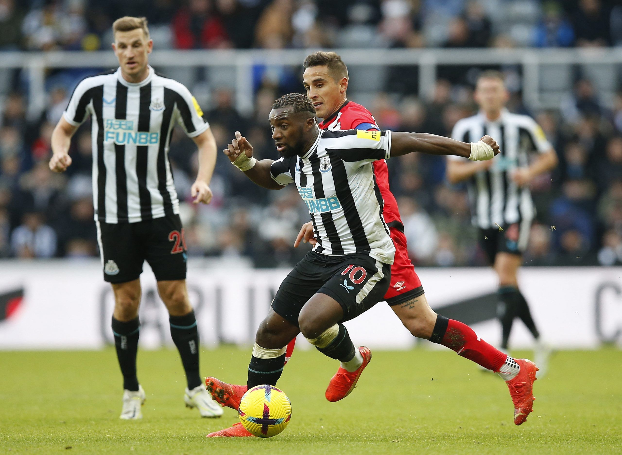 Soccer Football - Friendly - Newcastle United v Rayo Vallecano - St James' Park, Newcastle, Britain - December 17, 2022 Newcastle United's Allan Saint-Maximin in action with Rayo Vallecano's Oscar Trejo Action Images via Reuters/Craig Brough
