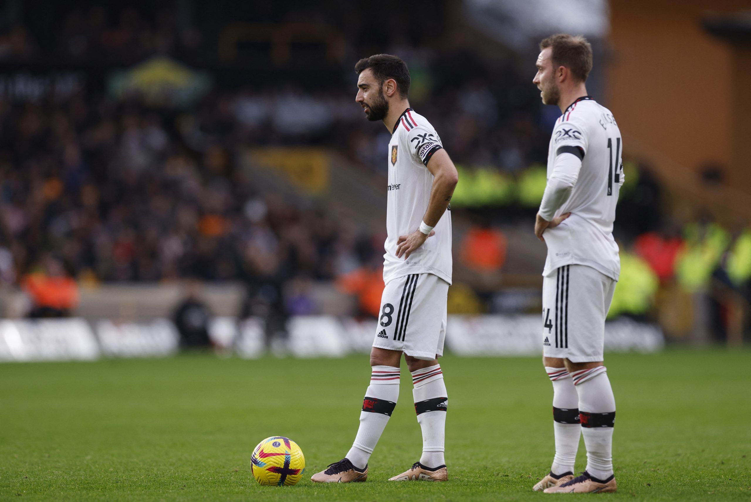 Soccer Football - Premier League - Wolverhampton Wanderers v Manchester United - Molineux Stadium, Wolverhampton, Britain - December 31, 2022 Manchester United's Bruno Fernandes waits to take a free kick as Christian Eriksen looks on Action Images via Reuters/Andrew Couldridge EDITORIAL USE ONLY. No use with unauthorized audio, video, data, fixture lists, club/league logos or 'live' services. Online in-match use limited to 75 images, no video emulation. No use in betting, games or single club /l