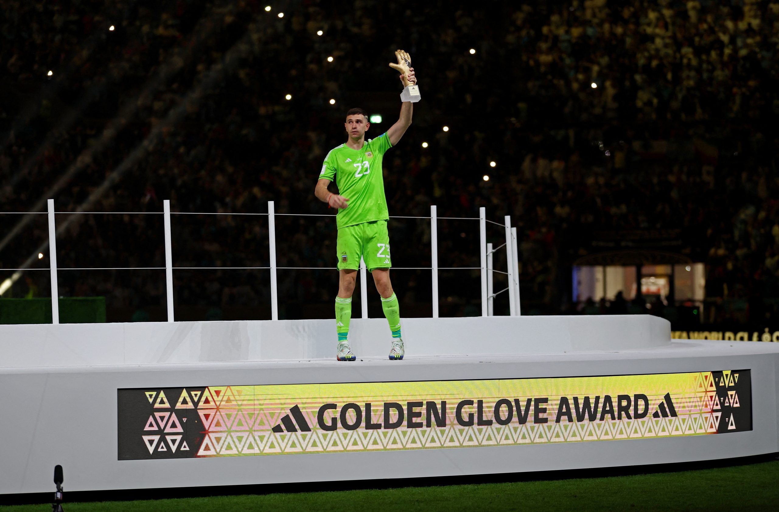 Soccer Football - FIFA World Cup Qatar 2022 - Final - Argentina v France - Lusail Stadium, Lusail, Qatar - December 18, 2022   Argentina's Emiliano Martinez poses for a photograph after he is awarded the golden glove award during the trophy ceremony REUTERS/Hannah Mckay