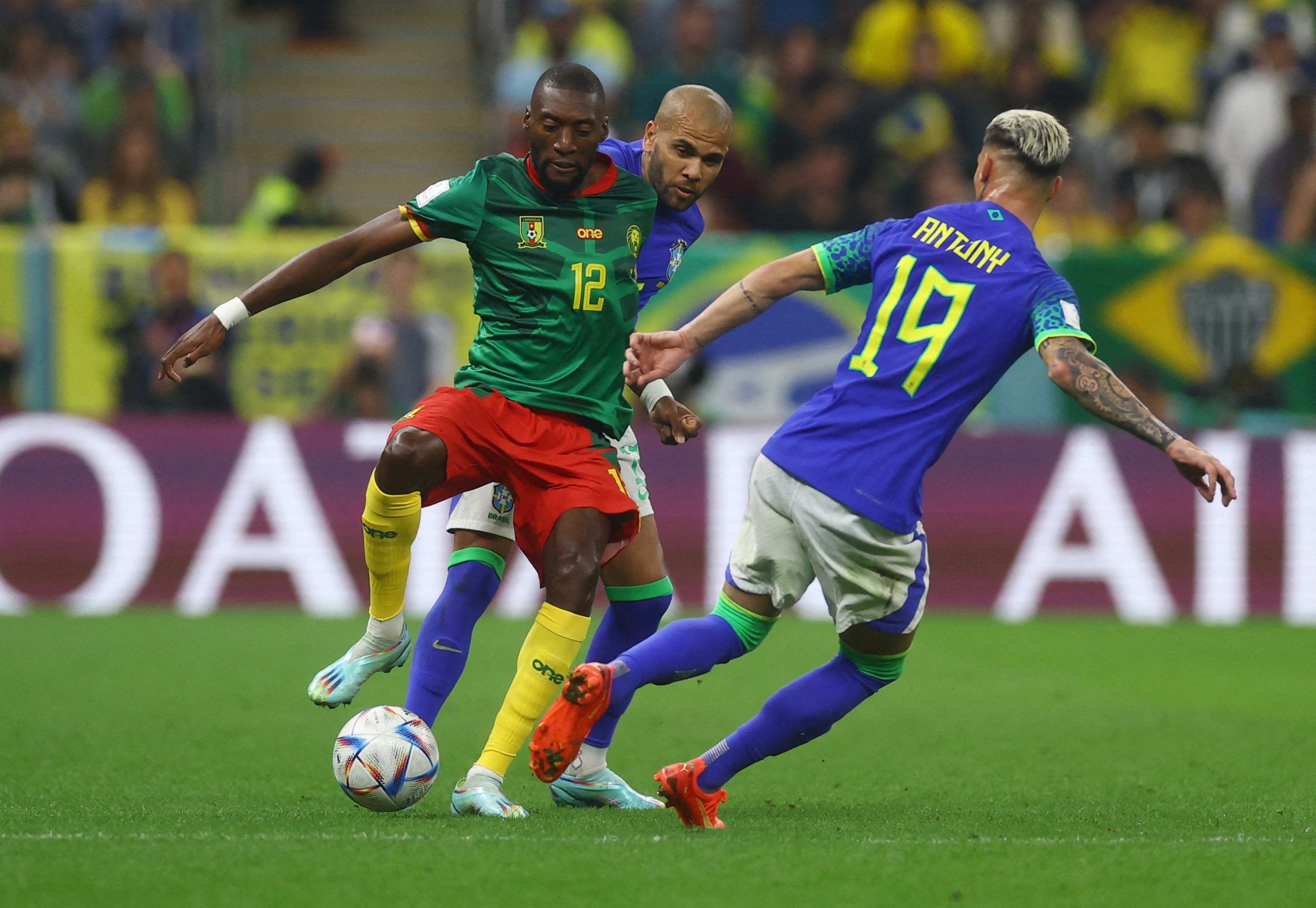 Soccer Football - FIFA World Cup Qatar 2022 - Group G - Cameroon v Brazil - Lusail Stadium, Lusail, Qatar - December 2, 2022 Cameroon's Karl Toko Ekambi in action with Brazil's Dani Alves and Antony REUTERS/Paul Childs