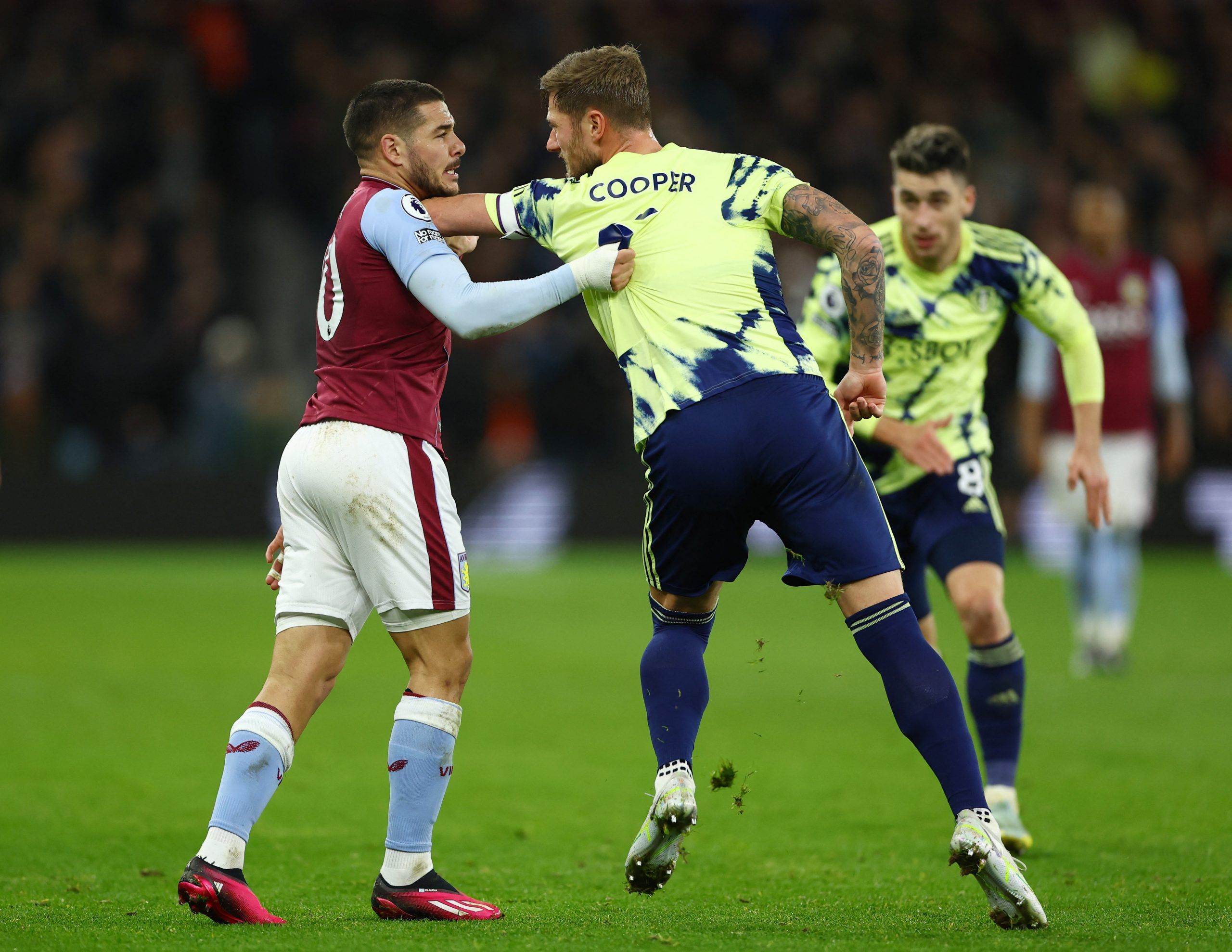 Aston Villa's Emiliano Buendia clashes with Leeds United's Liam Cooper