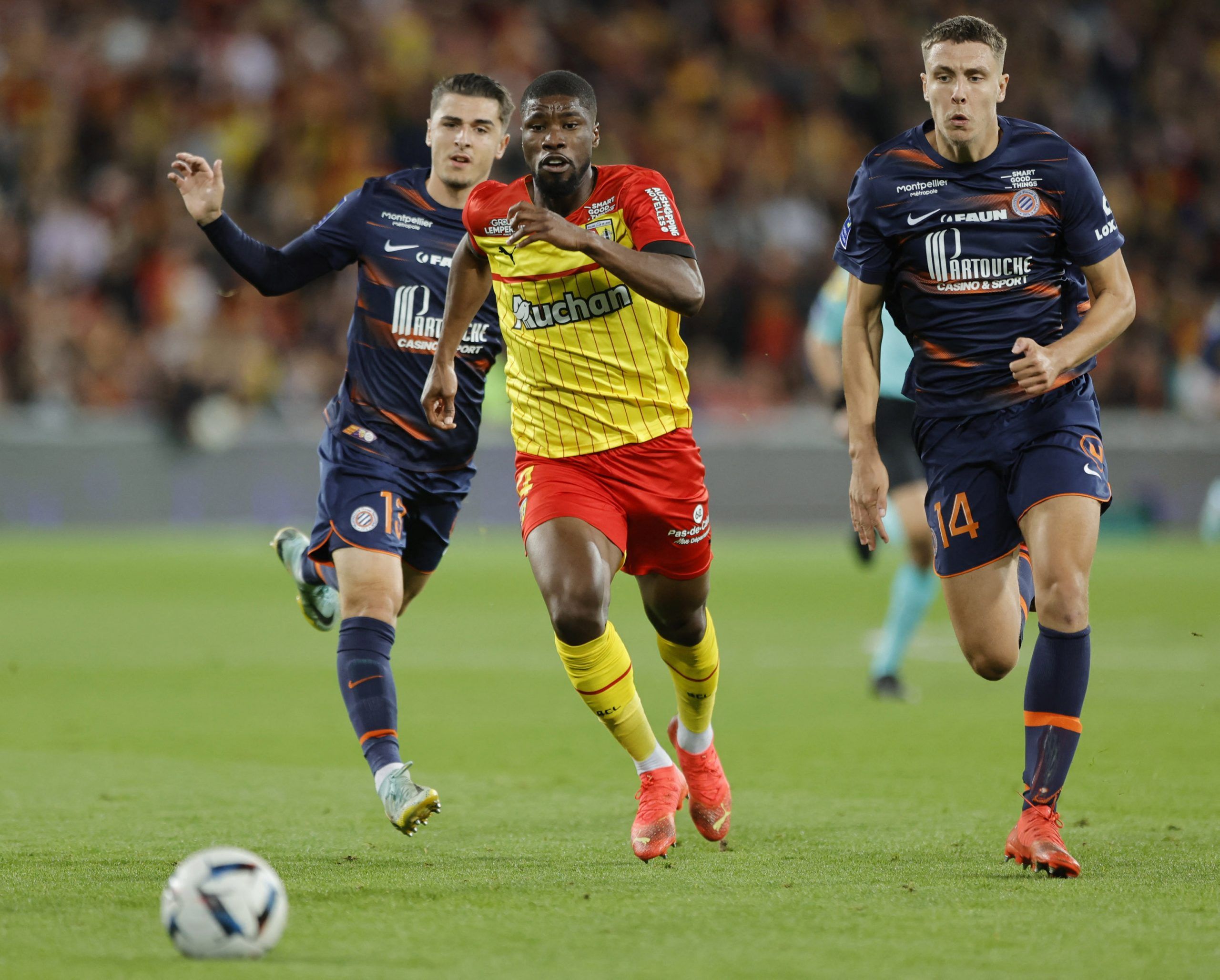 Soccer Football - Ligue 1 - RC Lens v Montpellier - Stade Bollaert-Delelis, Lens, France - October 15, 2022 RC Lens' Kevin Danso in action with Montpellier's Joris Chotard and Maxime Esteve REUTERS/Pascal Rossignol