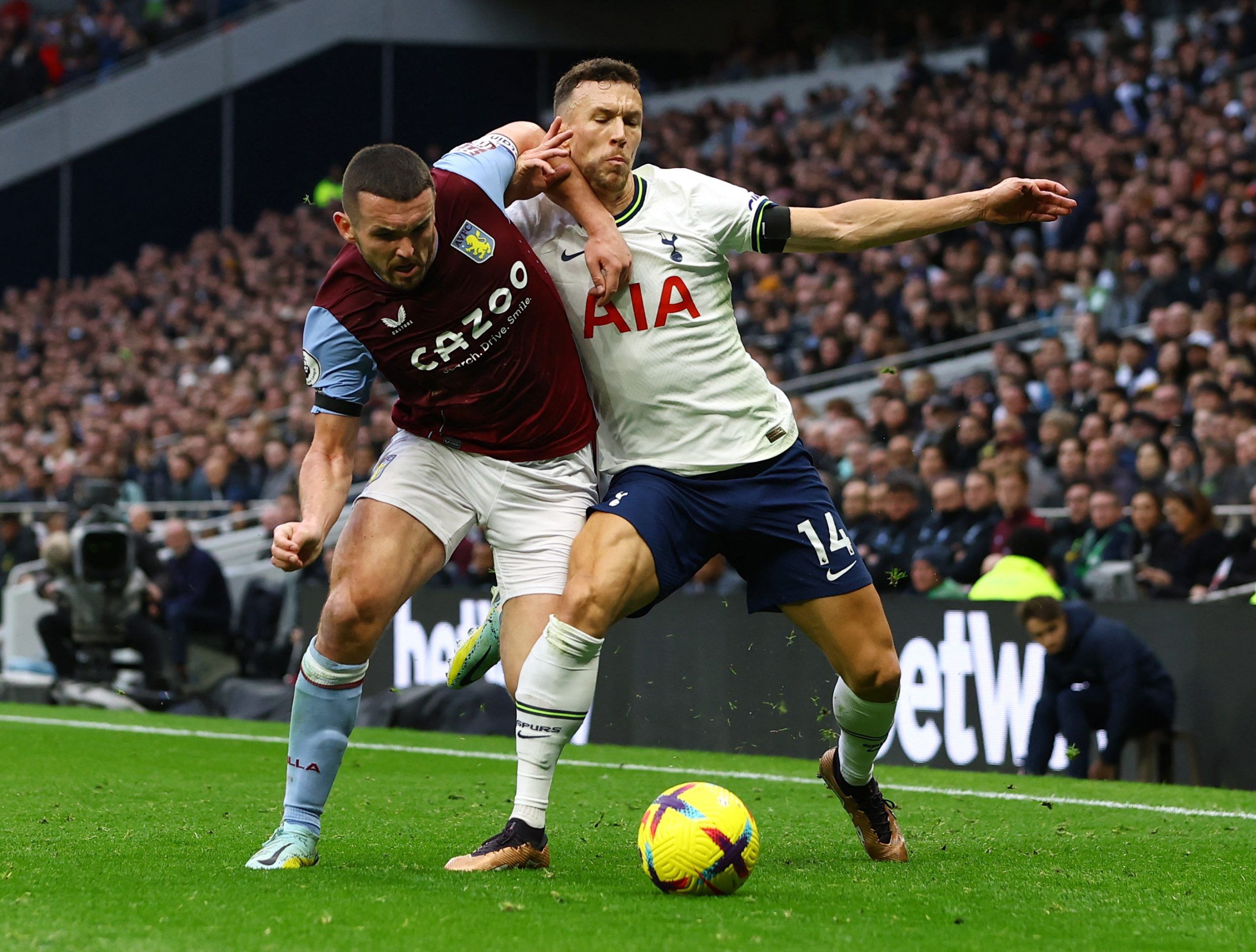 Soccer Football - Premier League - Tottenham Hotspur v Aston Villa - Tottenham Hotspur Stadium, London, Britain - January 1, 2023 Aston Villa's John McGinn in action with Tottenham Hotspur's Ivan Perisic Action Images via Reuters/Paul Childs EDITORIAL USE ONLY. No use with unauthorized audio, video, data, fixture lists, club/league logos or 'live' services. Online in-match use limited to 75 images, no video emulation. No use in betting, games or single club /league/player publications.  Please c