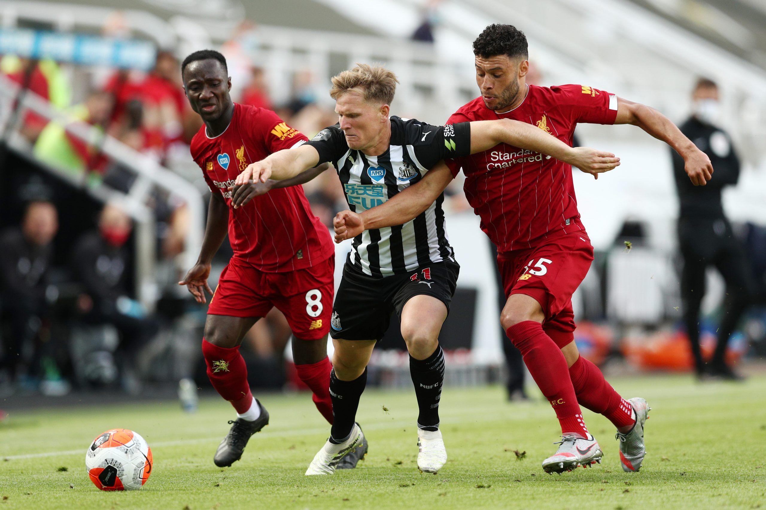 Soccer Football - Premier League - Newcastle United v Liverpool - St James' Park, Newcastle, Britain - July 26, 2020  Newcastle United's Matt Ritchie in action with Liverpool's Alex Oxlade-Chamberlain and Naby Keita, as play resumes behind closed doors following the outbreak of the coronavirus disease (COVID-19) Pool via REUTERS/Jan Kruger EDITORIAL USE ONLY. No use with unauthorized audio, video, data, fixture lists, club/league logos or 'live' services. Online in-match use limited to 75 images