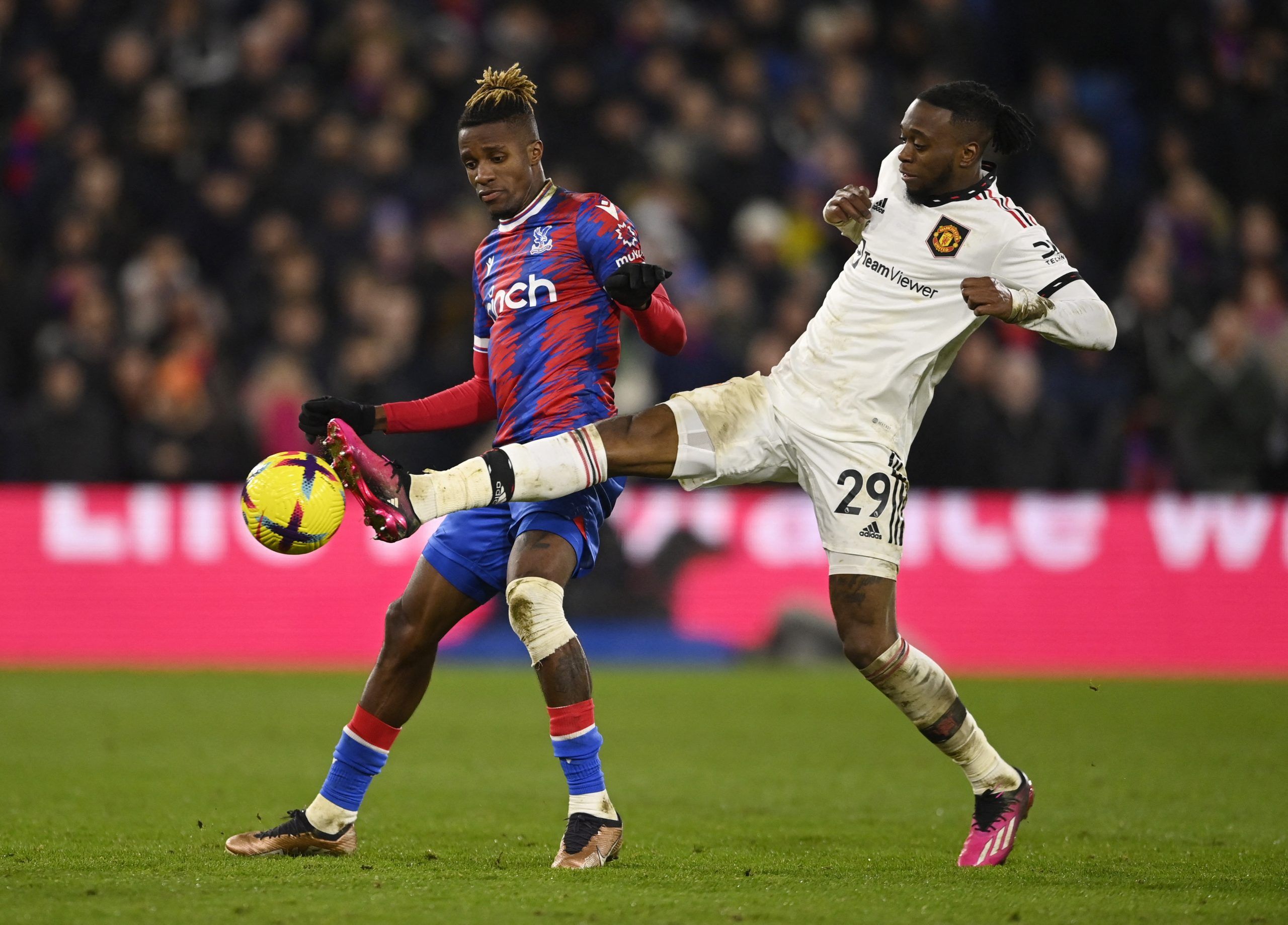 Soccer Football - Premier League - Crystal Palace v Manchester United - Selhurst Park, London, Britain - January 18, 2023 Crystal Palace's Wilfried Zaha in action with Manchester United's Aaron Wan-Bissaka REUTERS/Tony Obrien EDITORIAL USE ONLY. No use with unauthorized audio, video, data, fixture lists, club/league logos or 'live' services. Online in-match use limited to 75 images, no video emulation. No use in betting, games or single club /league/player publications.  Please contact your acco