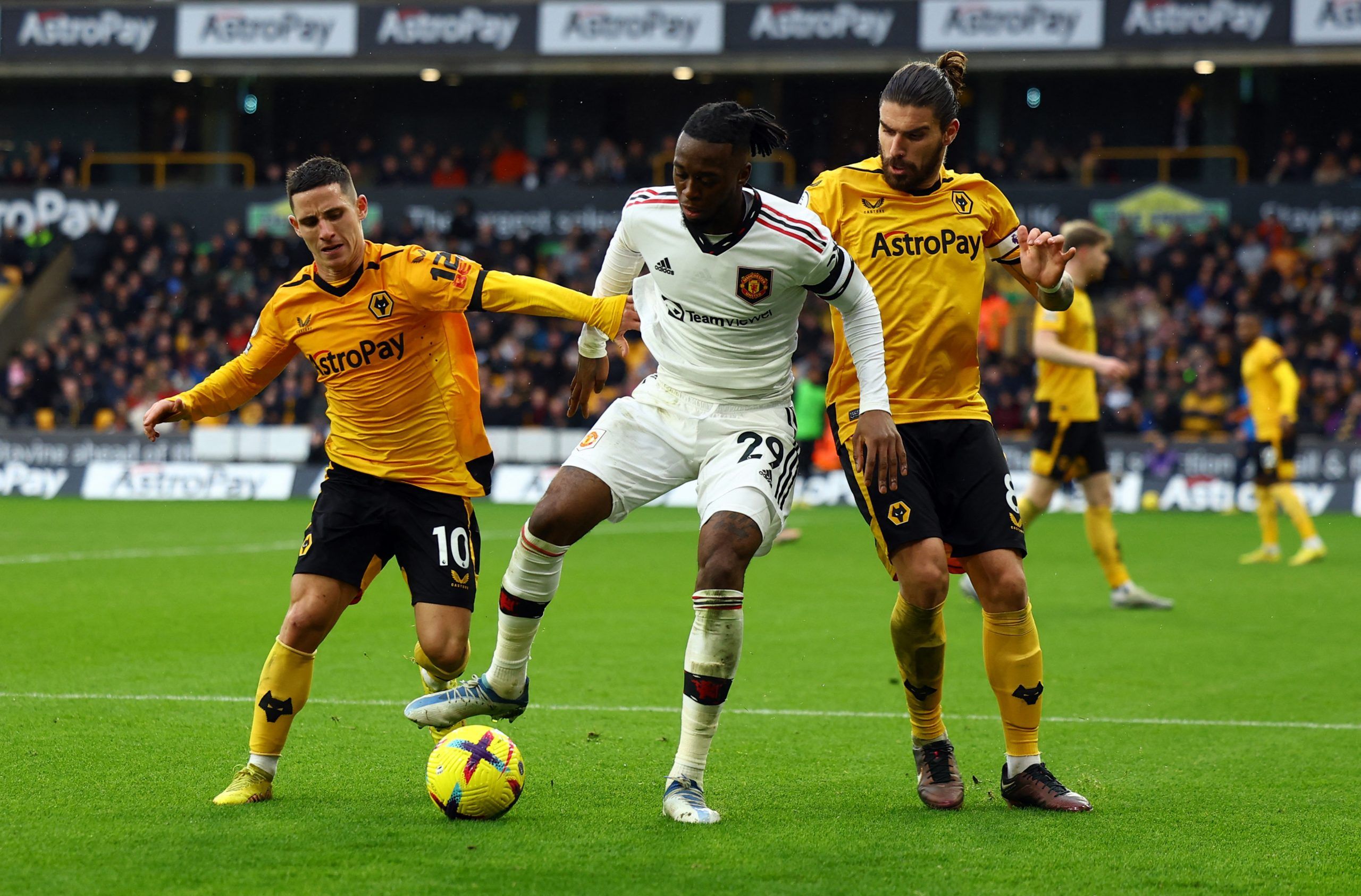 Soccer Football - Premier League - Wolverhampton Wanderers v Manchester United - Molineux Stadium, Wolverhampton, Britain - December 31, 2022 Manchester United's Aaron Wan-Bissaka in action with Wolverhampton Wanderers' Daniel Podence and Ruben Neves REUTERS/Molly Darlington EDITORIAL USE ONLY. No use with unauthorized audio, video, data, fixture lists, club/league logos or 'live' services. Online in-match use limited to 75 images, no video emulation. No use in betting, games or single club /lea