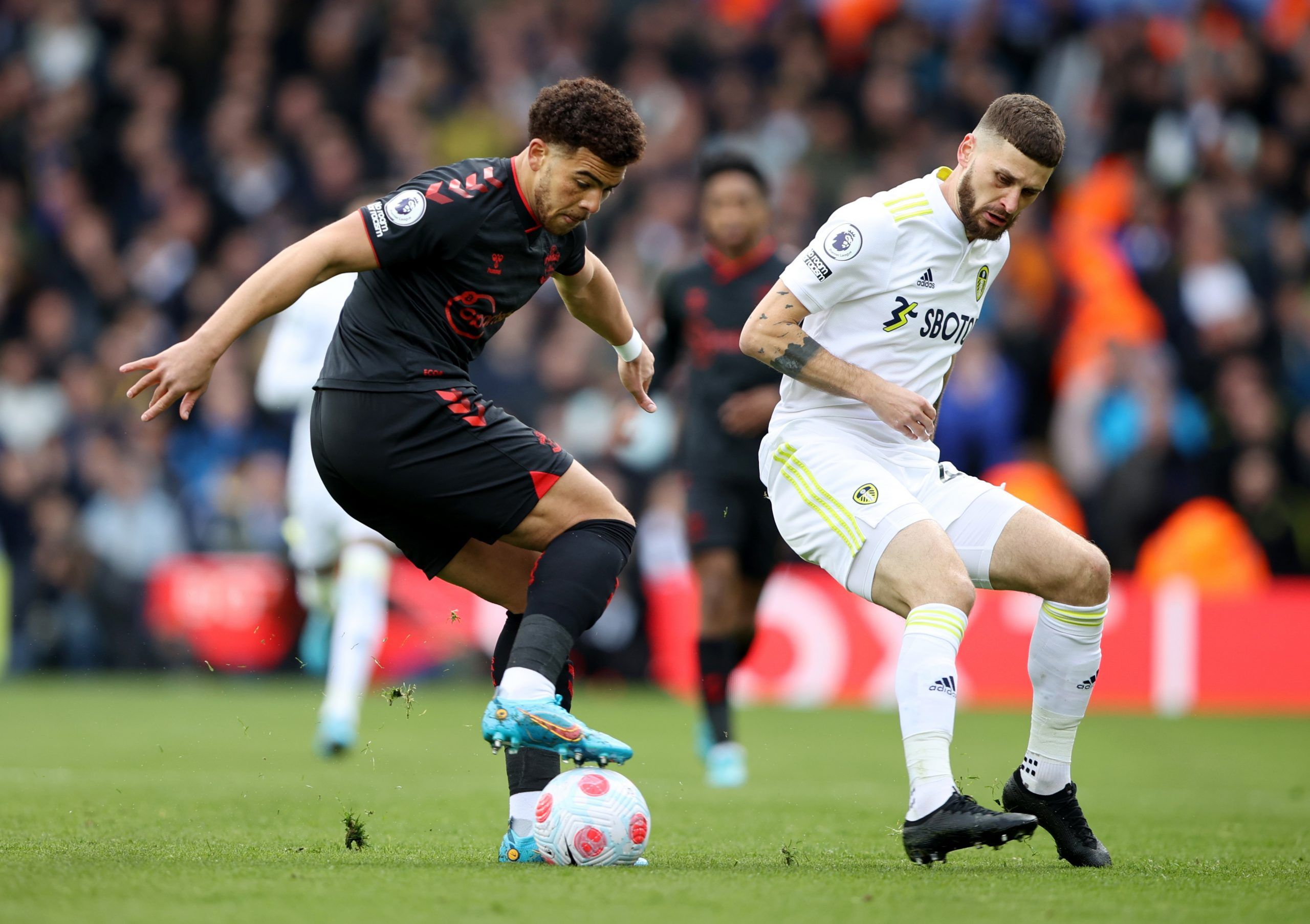 Southampton's Che Adams in action with Leeds United's Mateusz Klich