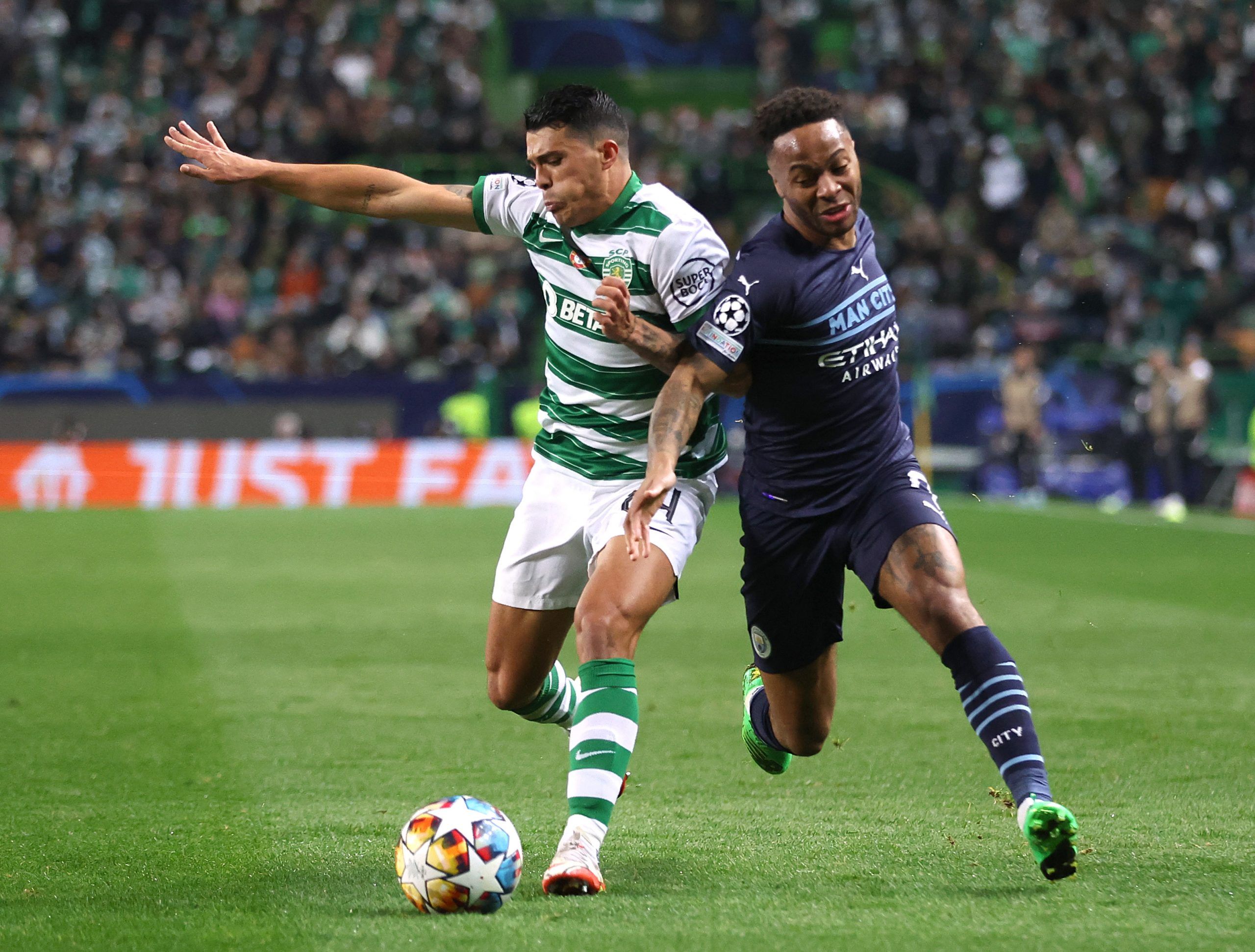 Sporting CP's Pedro Porro in action with Manchester City's Raheem Sterling 
