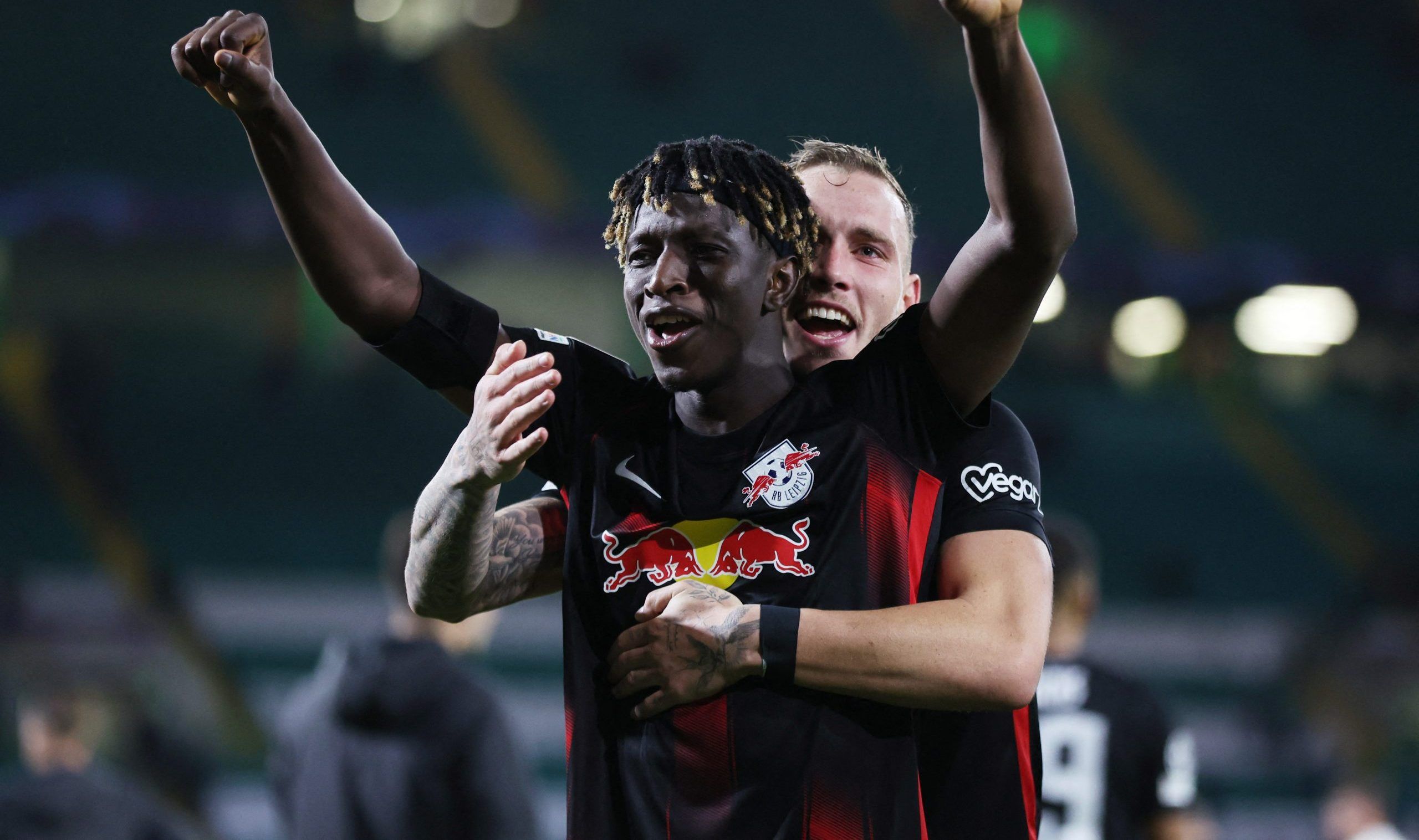 Soccer Football - Champions League - Group F - Celtic v RB Leipzig - Celtic Park, Glasgow, Scotland, Britain - October 11, 2022  RB Leipzig's Amadou Haidara and David Raum celebrate after the match Action Images via Reuters/Lee Smith