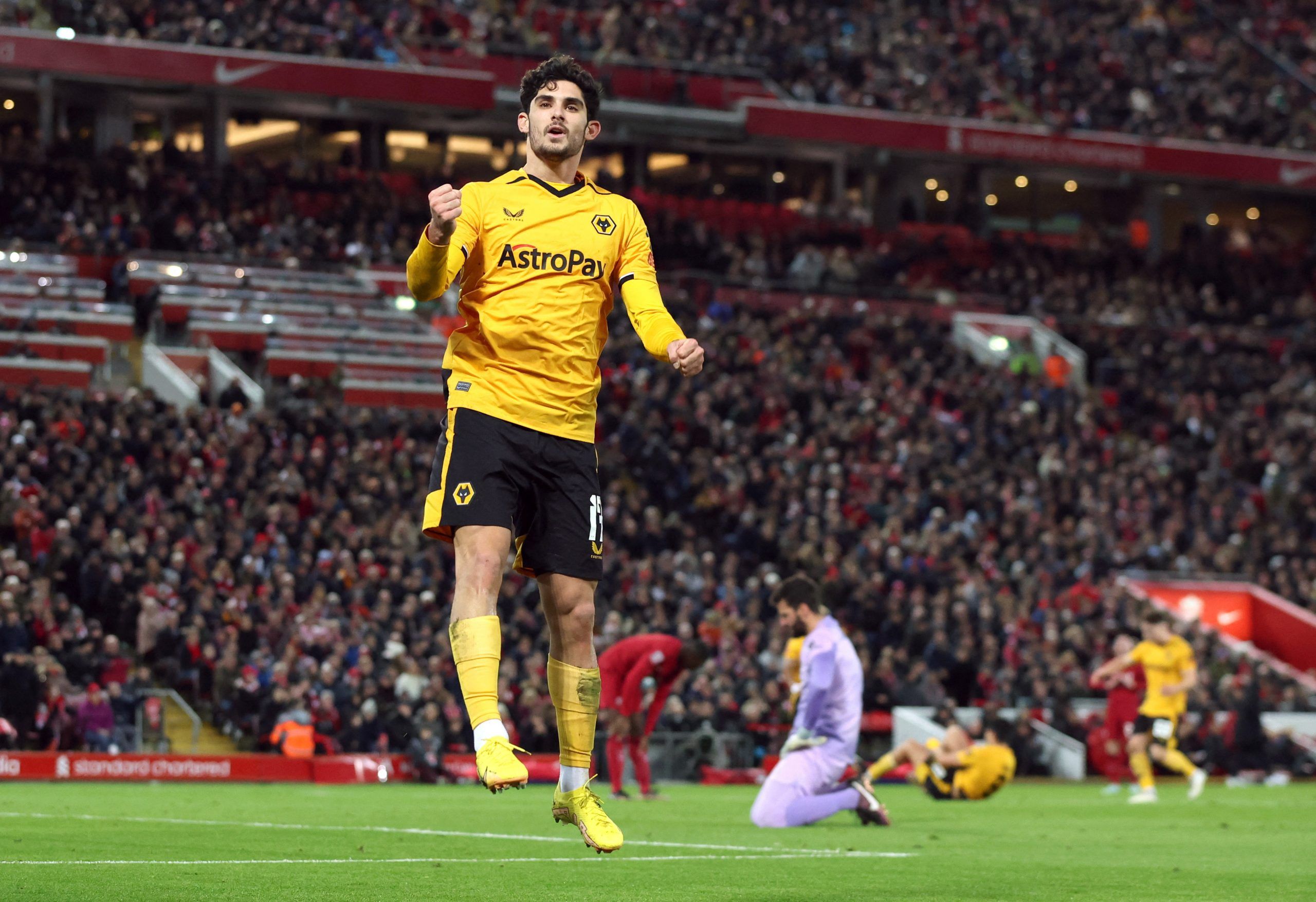 Soccer Football - FA Cup Third Round - Liverpool v Wolverhampton Wanderers - Anfield, Liverpool, Britain - January 7, 2023 Wolverhampton Wanderers' Goncalo Guedes celebrates scoring their first goal as Liverpool's Alisson looks dejected REUTERS/Phil Noble