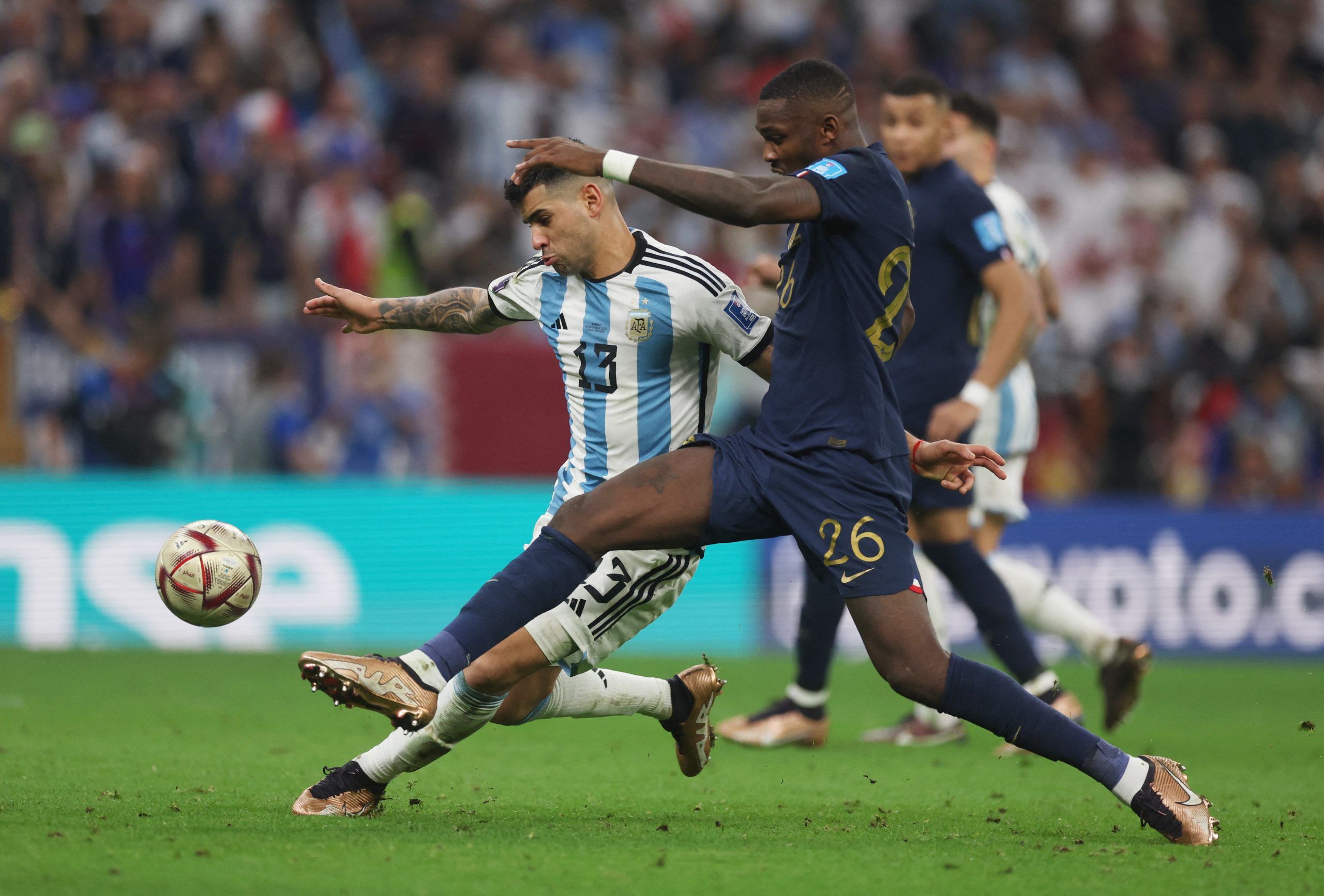 Soccer Football - FIFA World Cup Qatar 2022 - Final - Argentina v France - Lusail Stadium, Lusail, Qatar - December 18, 2022 Argentina's Cristian Romero in action with France's Marcus Thuram REUTERS/Lee Smith