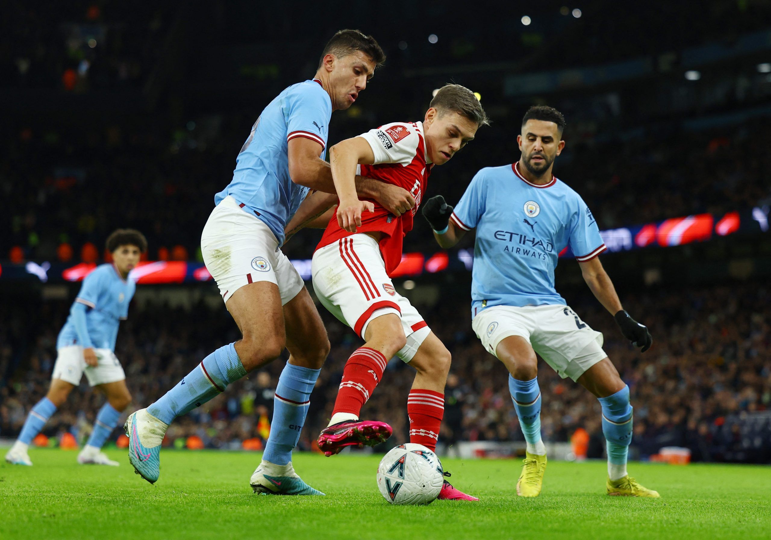 Arsenal's Leandro Trossard in action with Manchester City's Rodri 