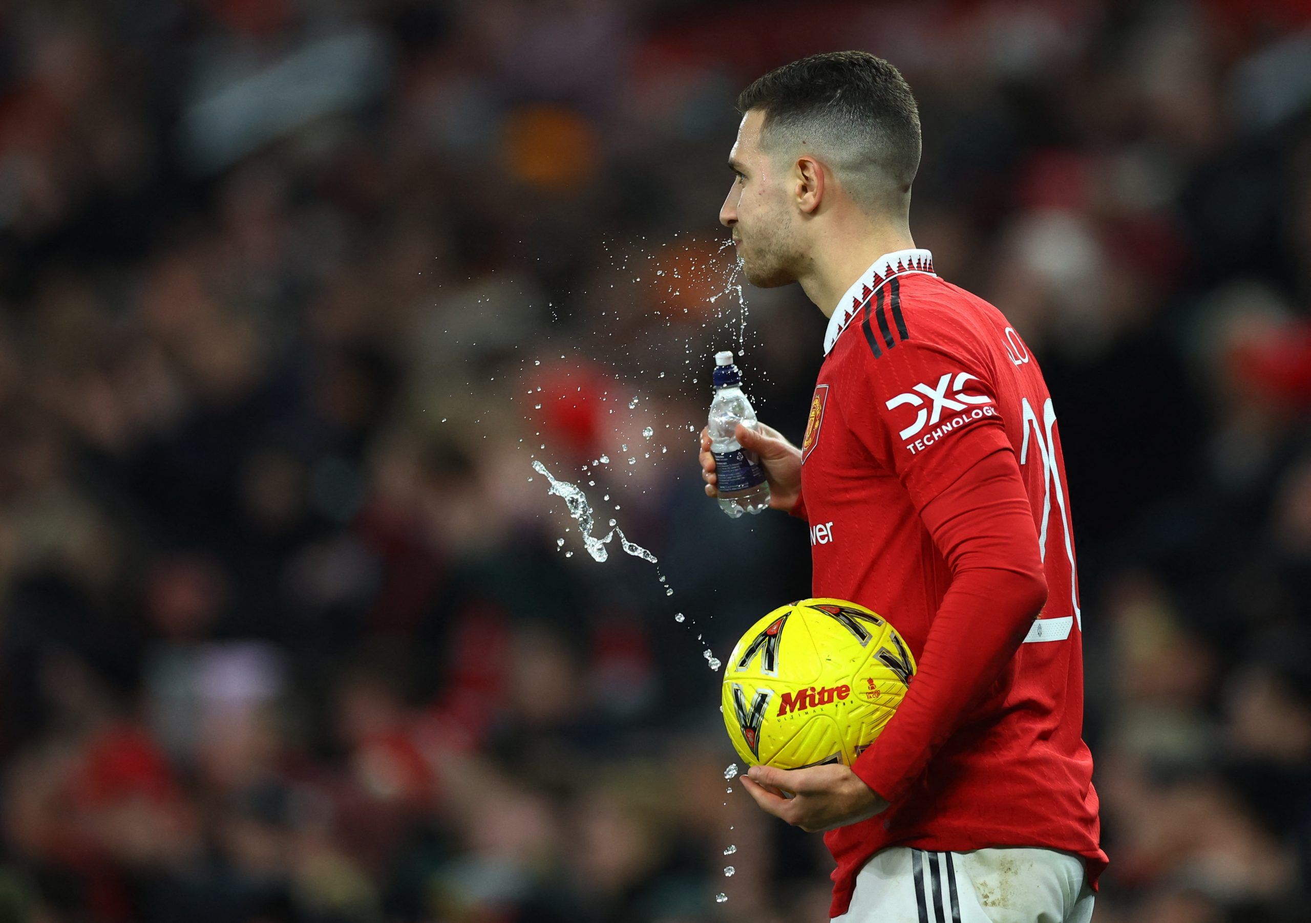 Soccer Football - FA Cup Third Round - Manchester United v Everton - Old Trafford, Manchester, Britain - January 6, 2023 Manchester United's Diogo Dalot spits out water during the match REUTERS/Carl Recine