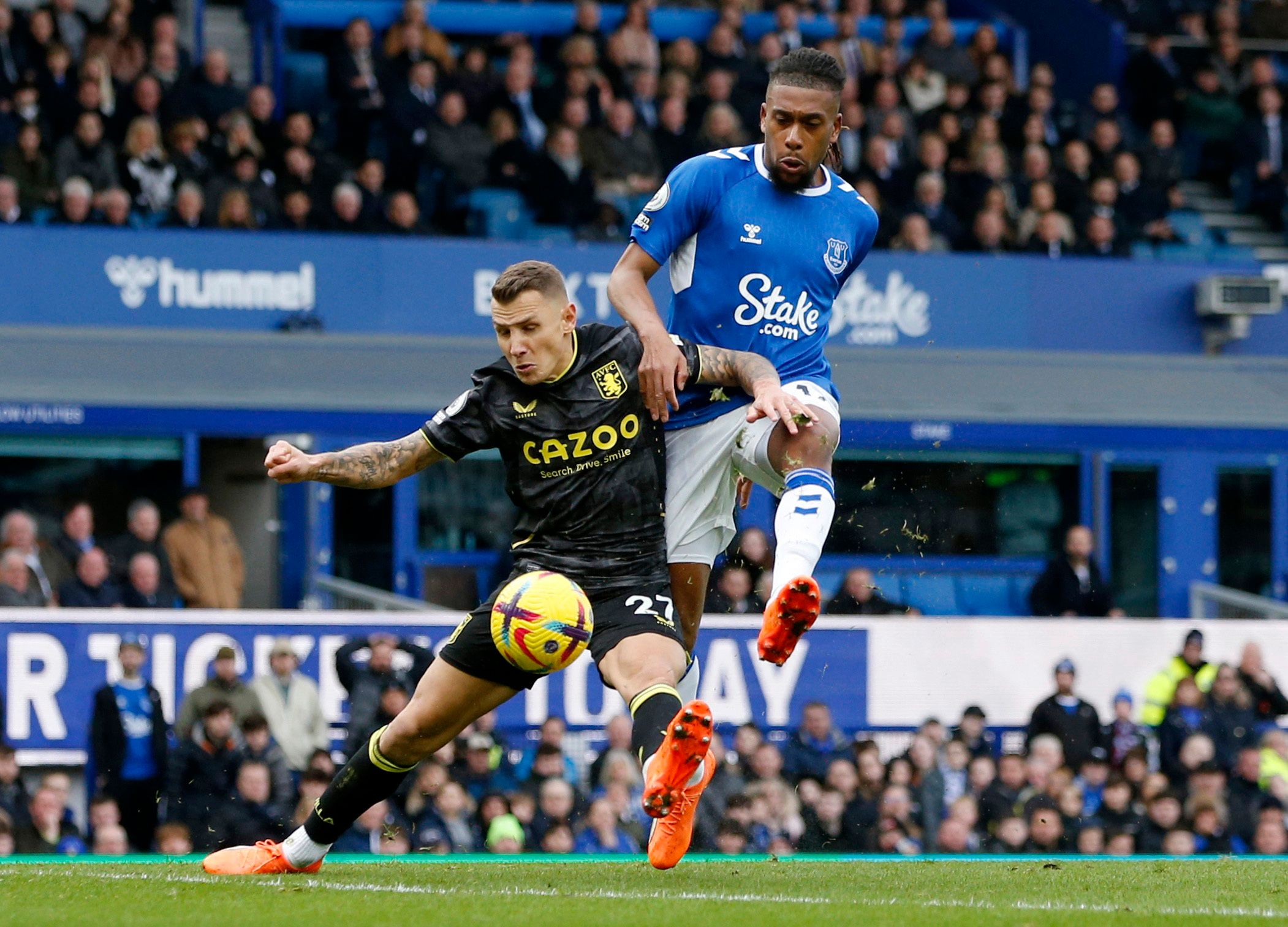 Soccer Football - Premier League - Everton v Aston Villa - Goodison Park, Liverpool, Britain - February 25, 2023 Aston Villa's Lucas Digne in action with Everton's Alex Iwobi Action Images via Reuters/Ed Sykes EDITORIAL USE ONLY. No use with unauthorized audio, video, data, fixture lists, club/league logos or 'live' services. Online in-match use limited to 75 images, no video emulation. No use in betting, games or single club /league/player publications.  Please contact your account representati