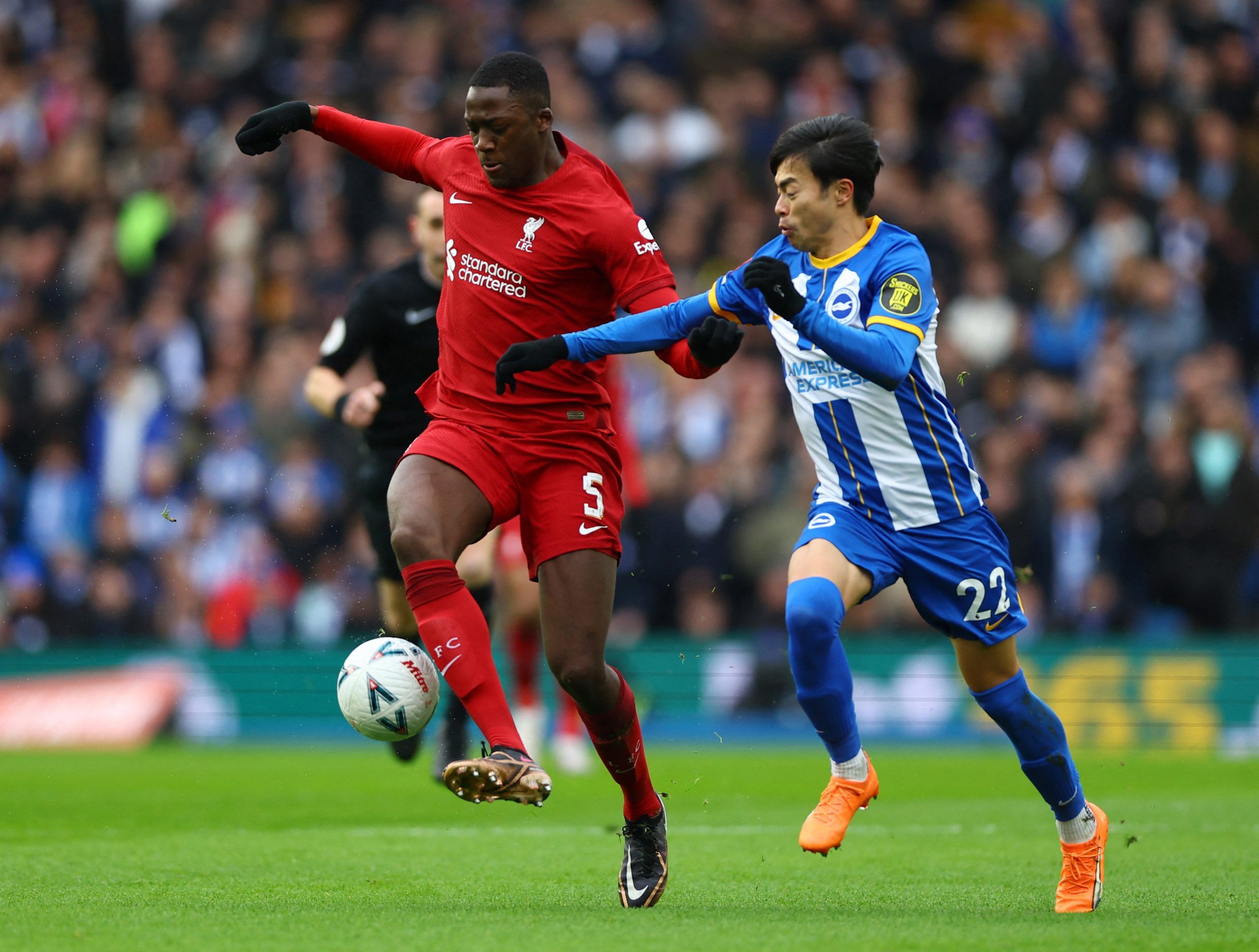 Soccer Football - FA Cup - Fourth Round - Brighton &amp; Hove Albion v Liverpool - The American Express Community Stadium, Brighton, Britain - January 29, 2023  Brighton &amp; Hove Albion's Kaoru Mitoma in action with Liverpool's Ibrahima Konate Action Images via Reuters/Matthew Childs