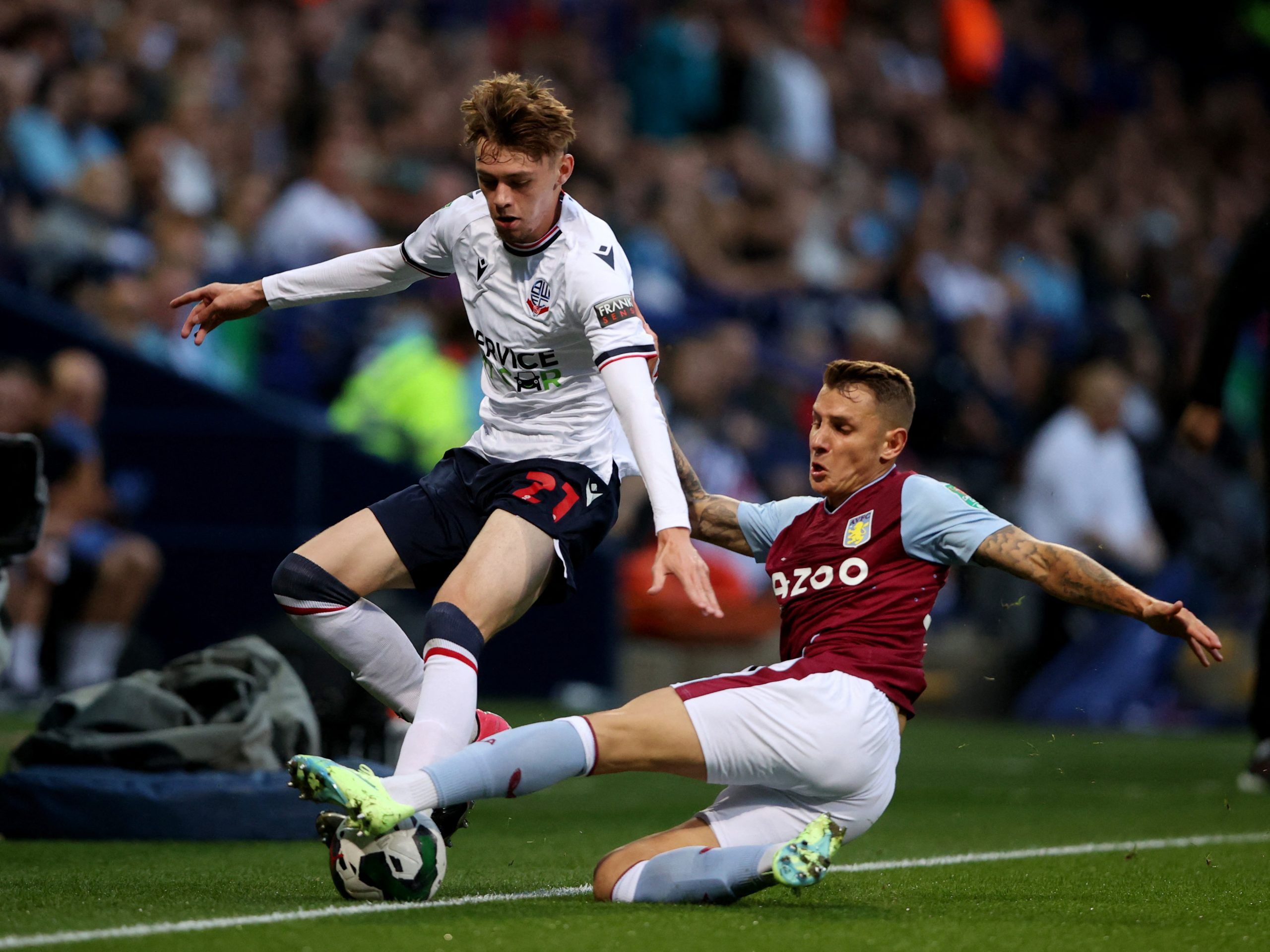 Soccer Football - Carabao Cup Second Round - Bolton Wanderers v Aston Villa - University of Bolton Stadium, Bolton, Britain - August 23, 2022 Bolton Wanderers' Conor Bradley in action with Aston Villa's Lucas Digne Action Images via Reuters/Molly Darlington EDITORIAL USE ONLY. No use with unauthorized audio, video, data, fixture lists, club/league logos or 'live' services. Online in-match use limited to 75 images, no video emulation. No use in betting, games or single club /league/player publica