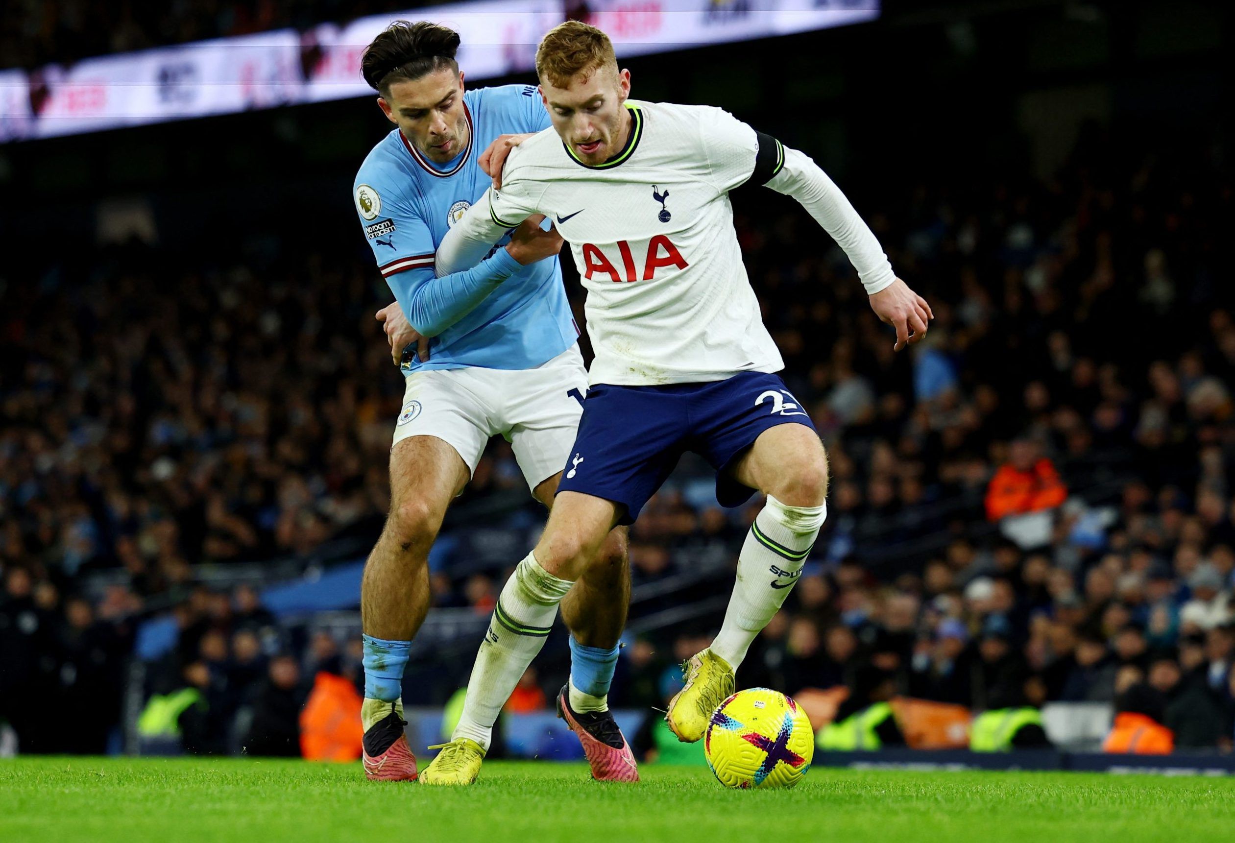 Manchester City's Jack Grealish in action with Tottenham Hotspur's Dejan Kulusevski