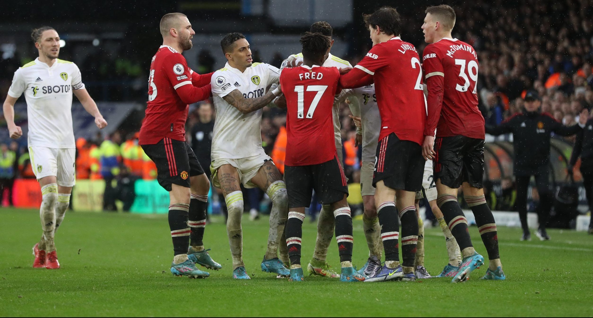Manchester United's Fred and Victor Lindelof clash with Leeds United's Junior Firpo and Raphinha