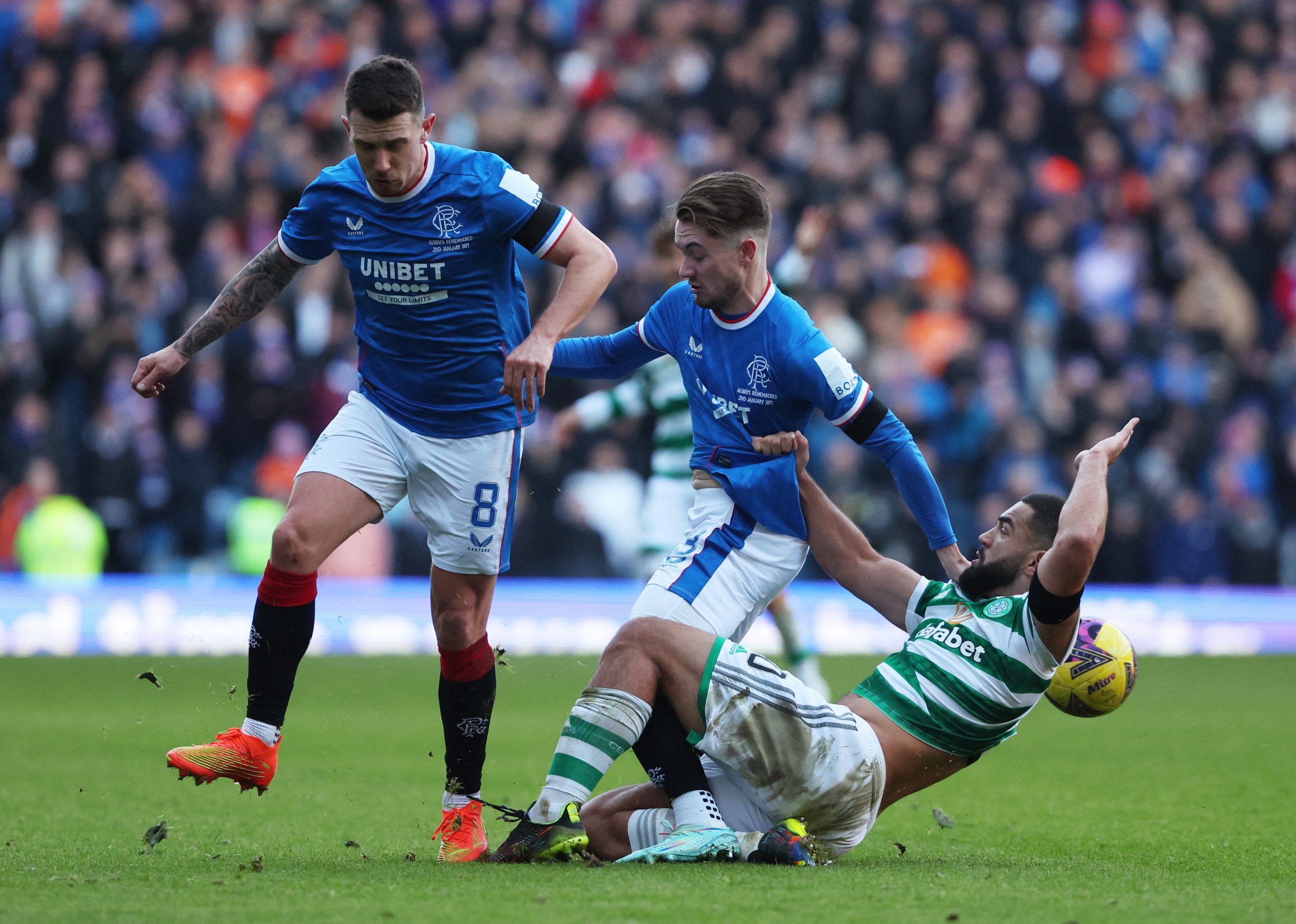 Soccer Football - Scottish Premiership - Rangers vs Celtic - Ibrox, Glasgow, Scotland, Britain - January 2, 2023 Rangers' Ryan Jack and Scott Wright in action with Celtic's Cameron Carter-Vickers REUTERS/Russell Cheyne