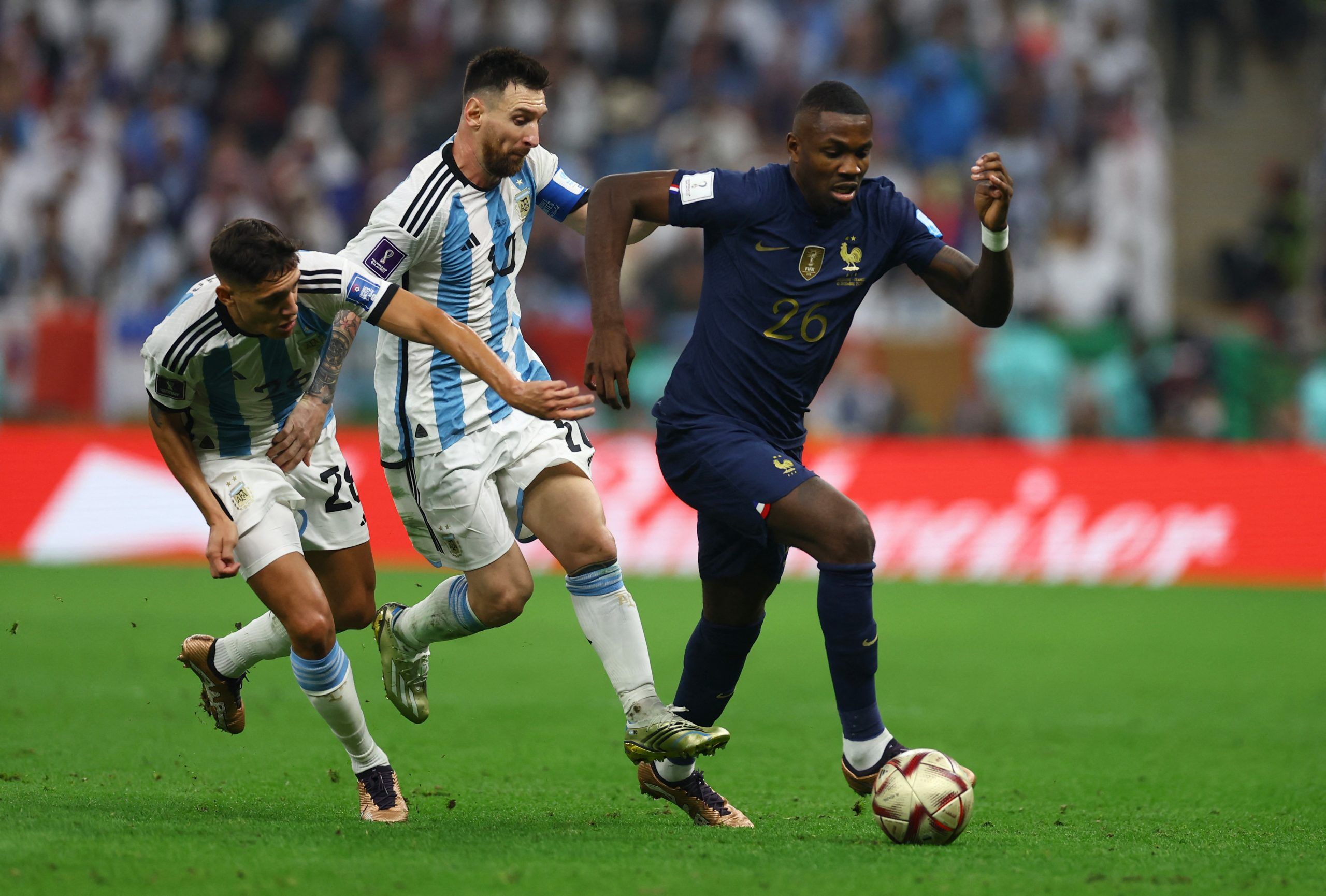 Soccer Football - FIFA World Cup Qatar 2022 - Final - Argentina v France - Lusail Stadium, Lusail, Qatar - December 18, 2022 France's Marcus Thuram in action with Argentina's Lionel Messi and Nahuel Molina REUTERS/Kai Pfaffenbach