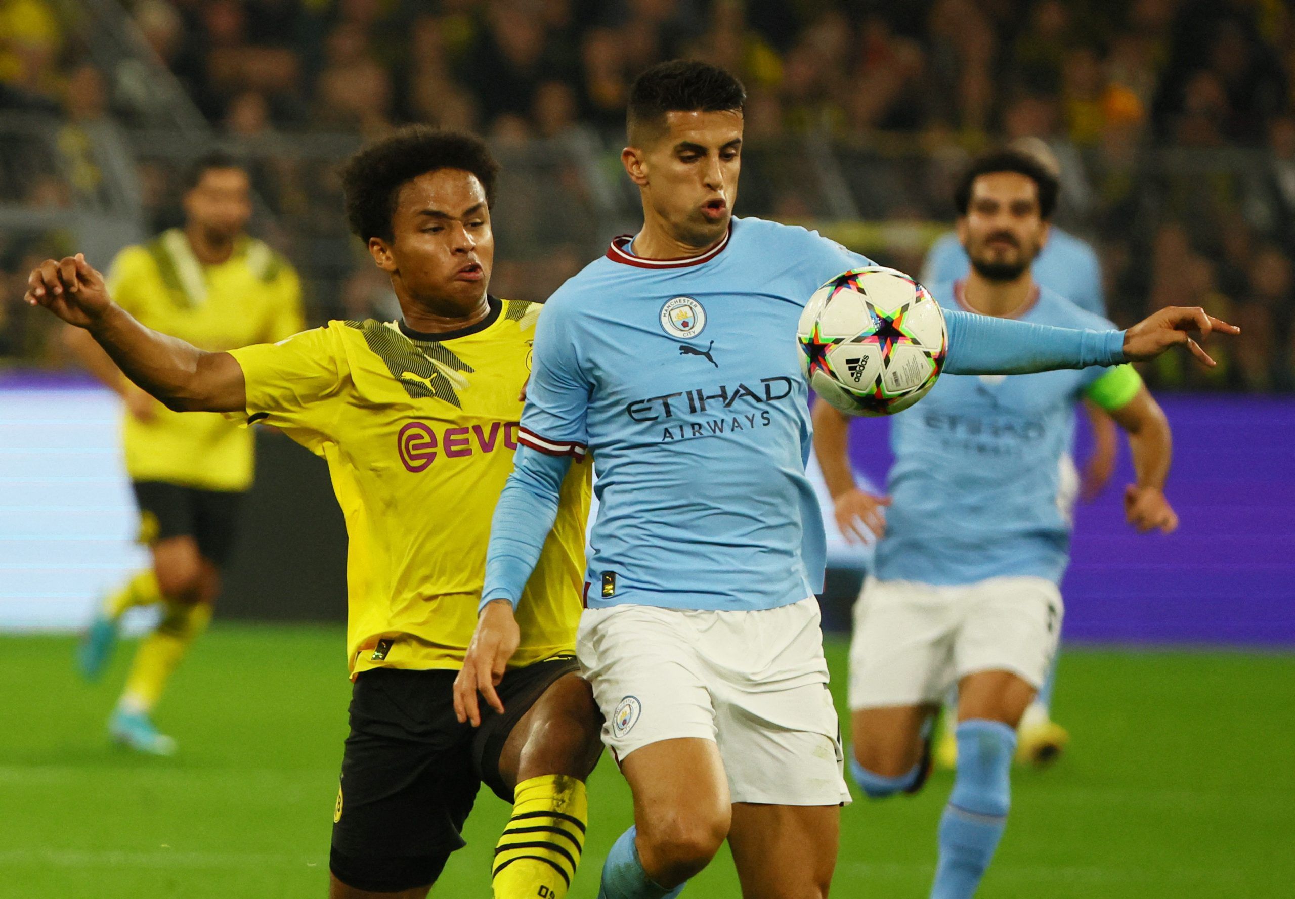 Soccer Football - Champions League - Group G - Borussia Dortmund v Manchester City - Signal Iduna Park, Dortmund, Germany - October 25, 2022 Borussia Dortmund's Karim Adeyemi in action with Manchester City's Joao Cancelo REUTERS/Wolfgang Rattay