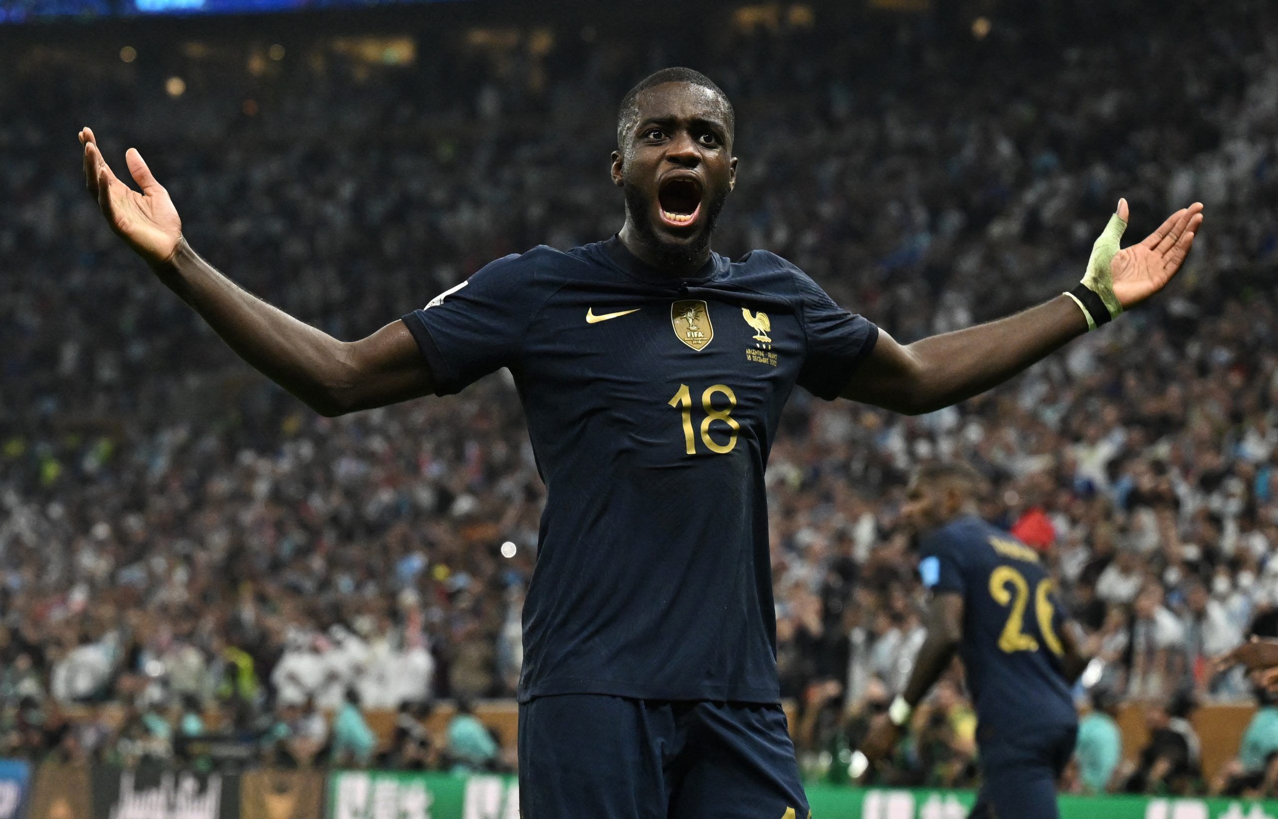 France's Dayot Upamecano celebrates their third goal scored by Kylian Mbappe vs Argentina during the World Cup final
