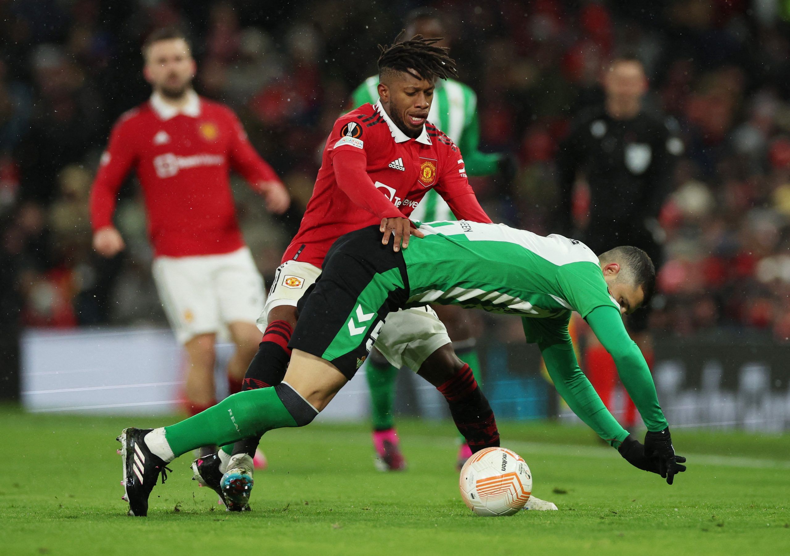 Soccer Football - Europa League - Round of 16 - First Leg - Manchester United v Real Betis - Old Trafford, Manchester, Britain - March 9, 2023 Manchester United's Fred in action with Real Betis' Guido Rodriguez REUTERS/Phil Noble