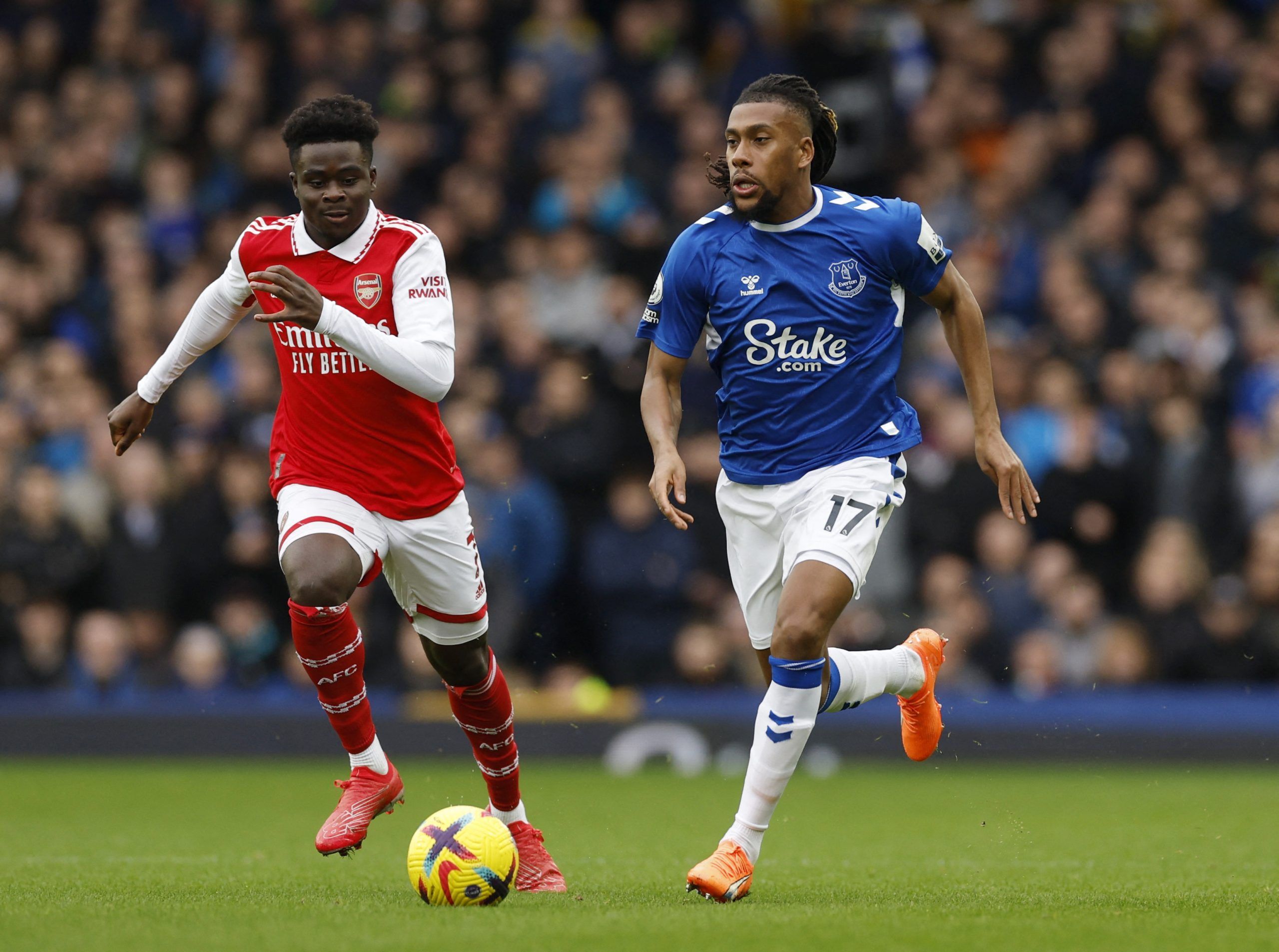 Soccer Football - Premier League - Everton v Arsenal - Goodison Park, Liverpool, Britain - February 4, 2023 Arsenal's Bukayo Saka in action with Everton's Alex Iwobi Action Images via Reuters/Jason Cairnduff EDITORIAL USE ONLY. No use with unauthorized audio, video, data, fixture lists, club/league logos or 'live' services. Online in-match use limited to 75 images, no video emulation. No use in betting, games or single club /league/player publications.  Please contact your account representative