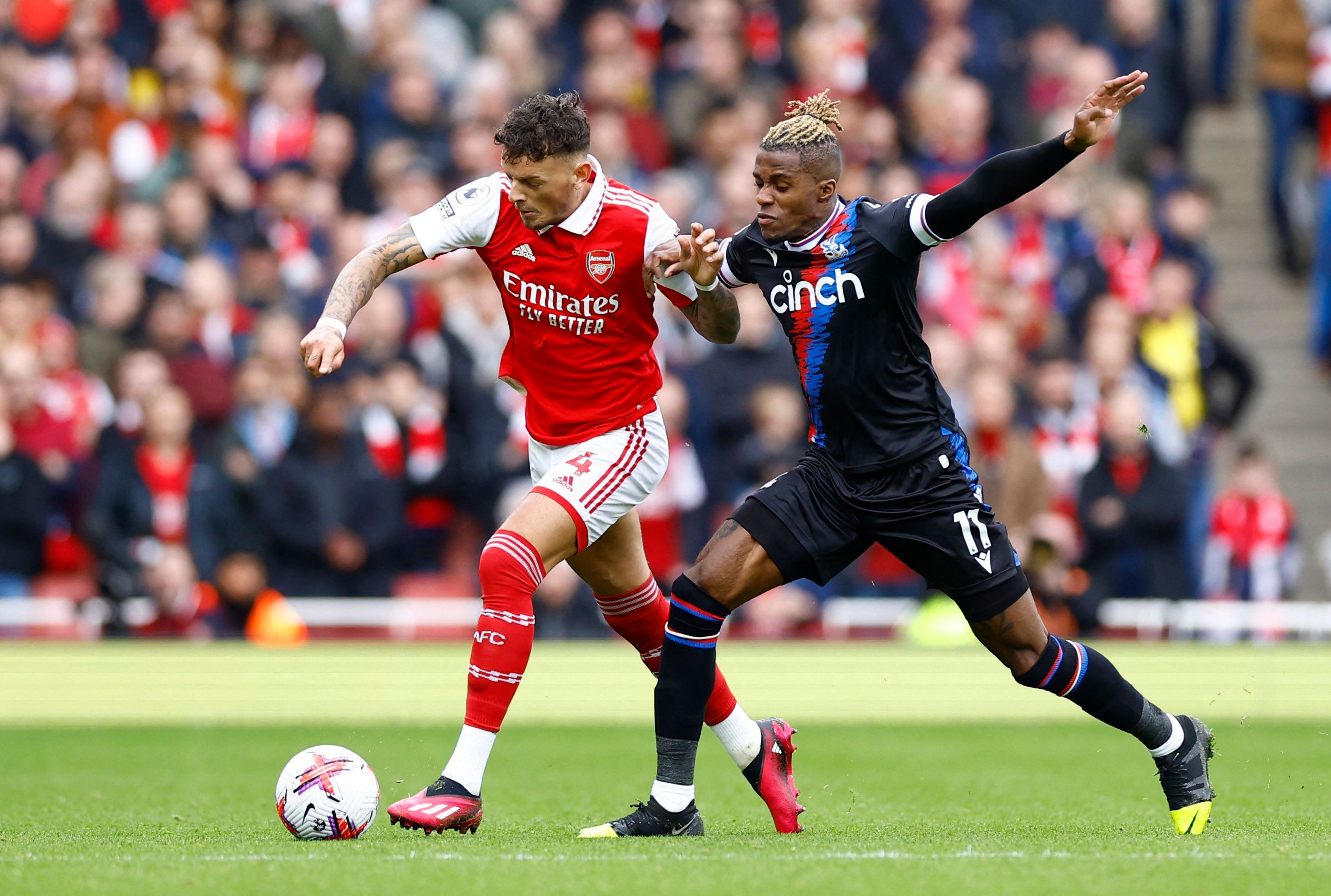 Arsenal's Ben White in action with Crystal Palace's Wilfried Zaha