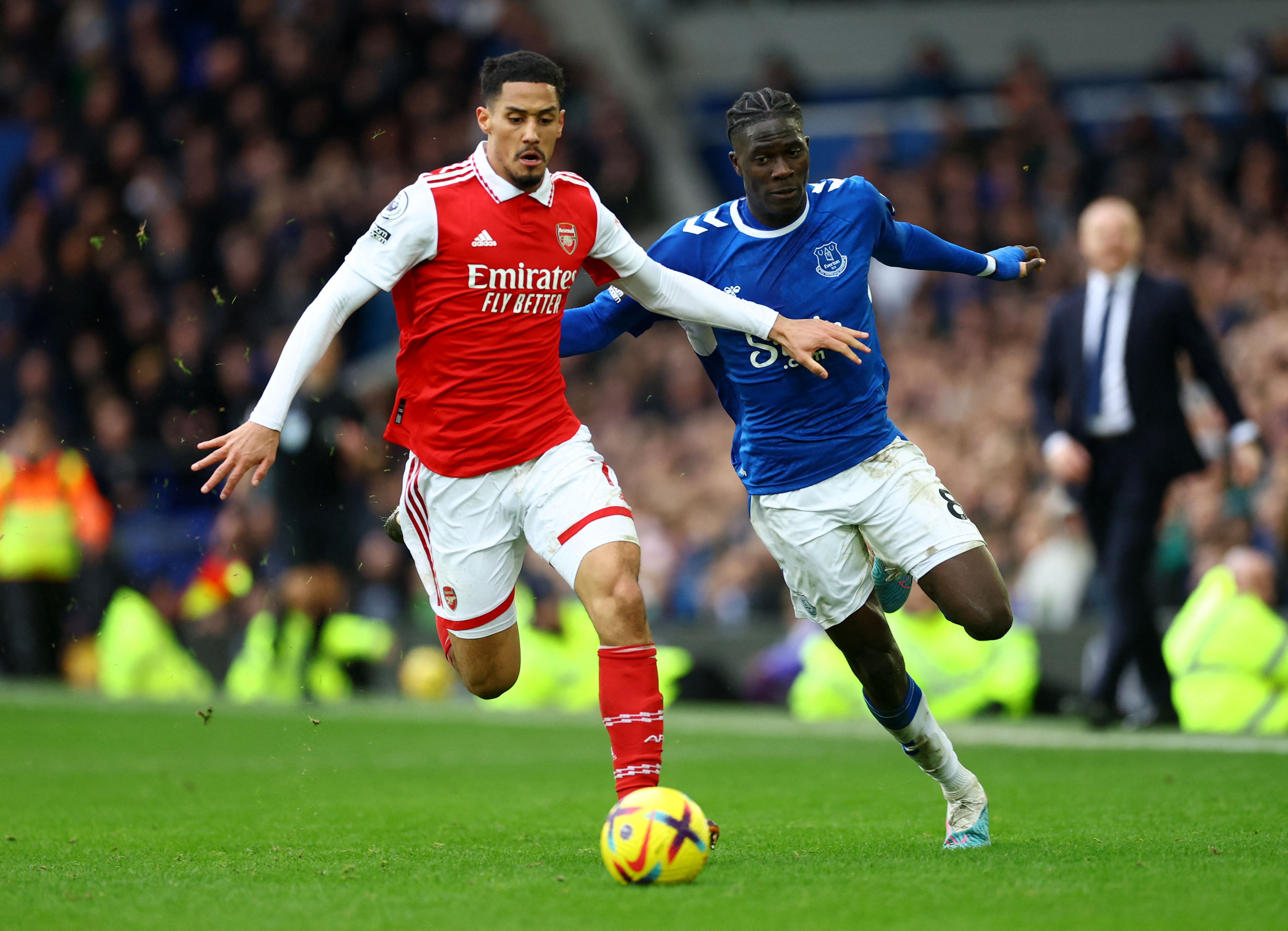 Arsenal's William Saliba in action with Everton's Amadou Onana