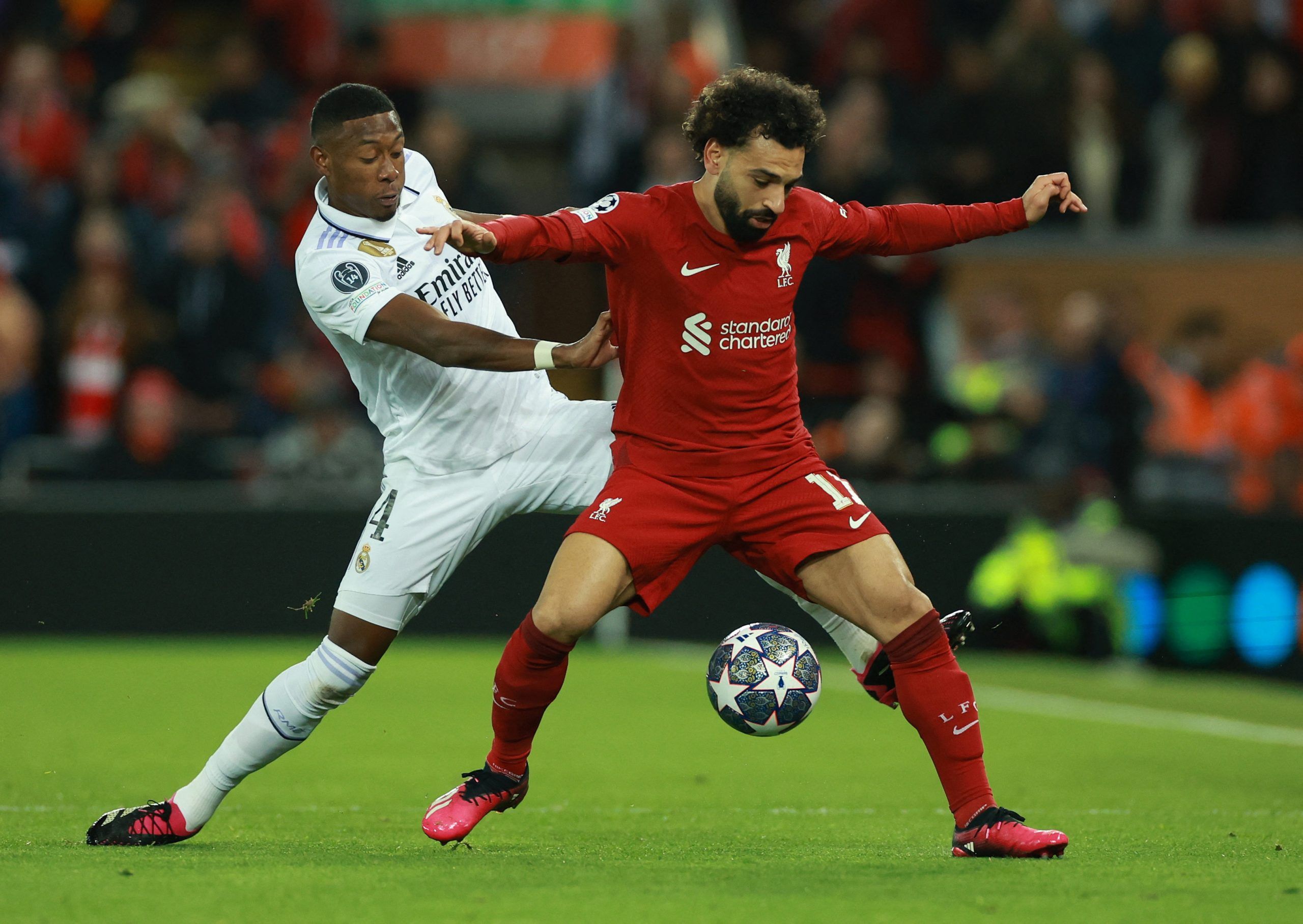 Soccer Football - Champions League - Round of 16 First Leg - Liverpool v Real Madrid - Anfield, Liverpool, Britain - February 21, 2023  Real Madrid's David Alaba in action with Liverpool's Mohamed Salah REUTERS/Phil Noble