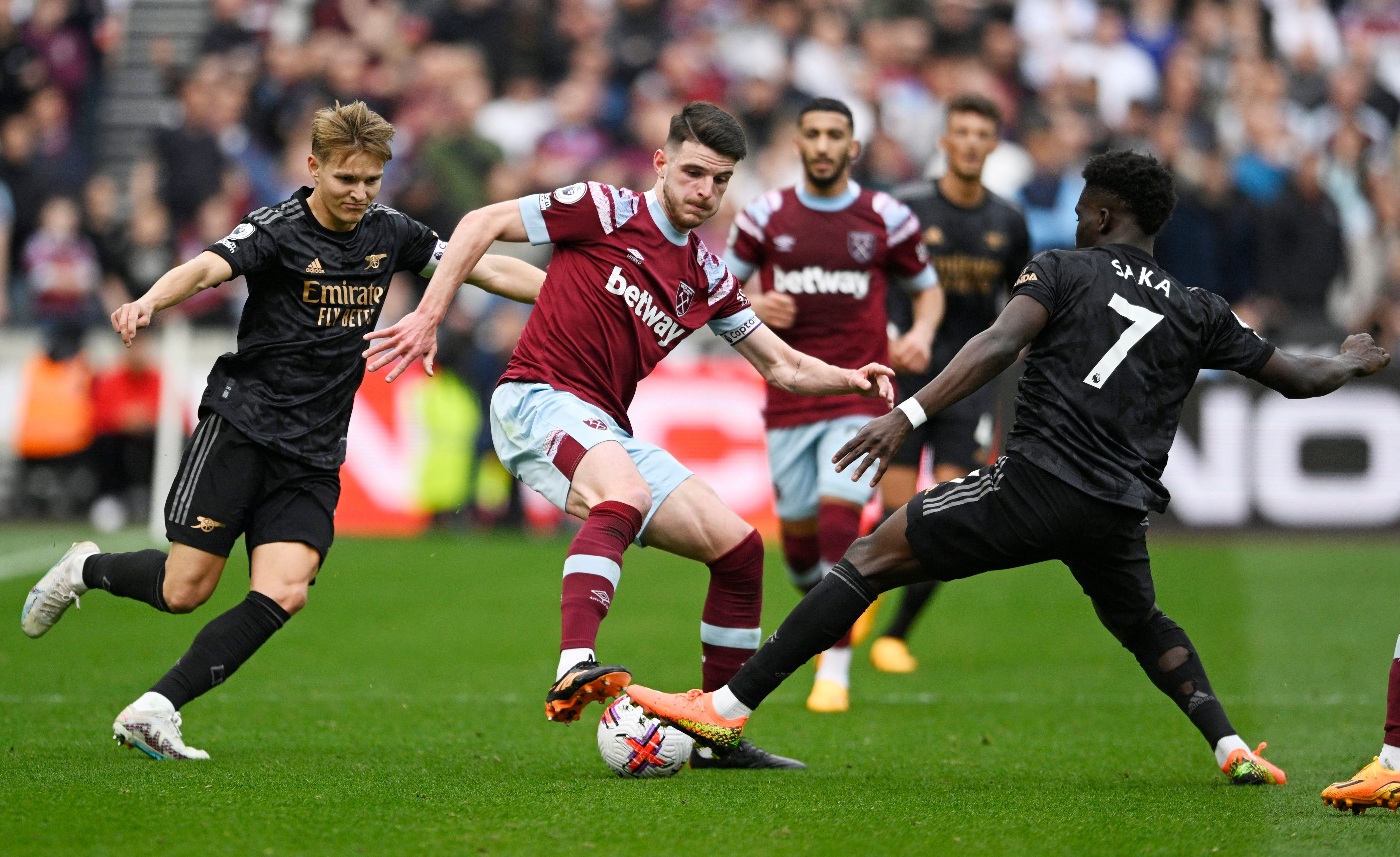 West Ham United's Declan Rice in action with Arsenal's Bukayo Saka