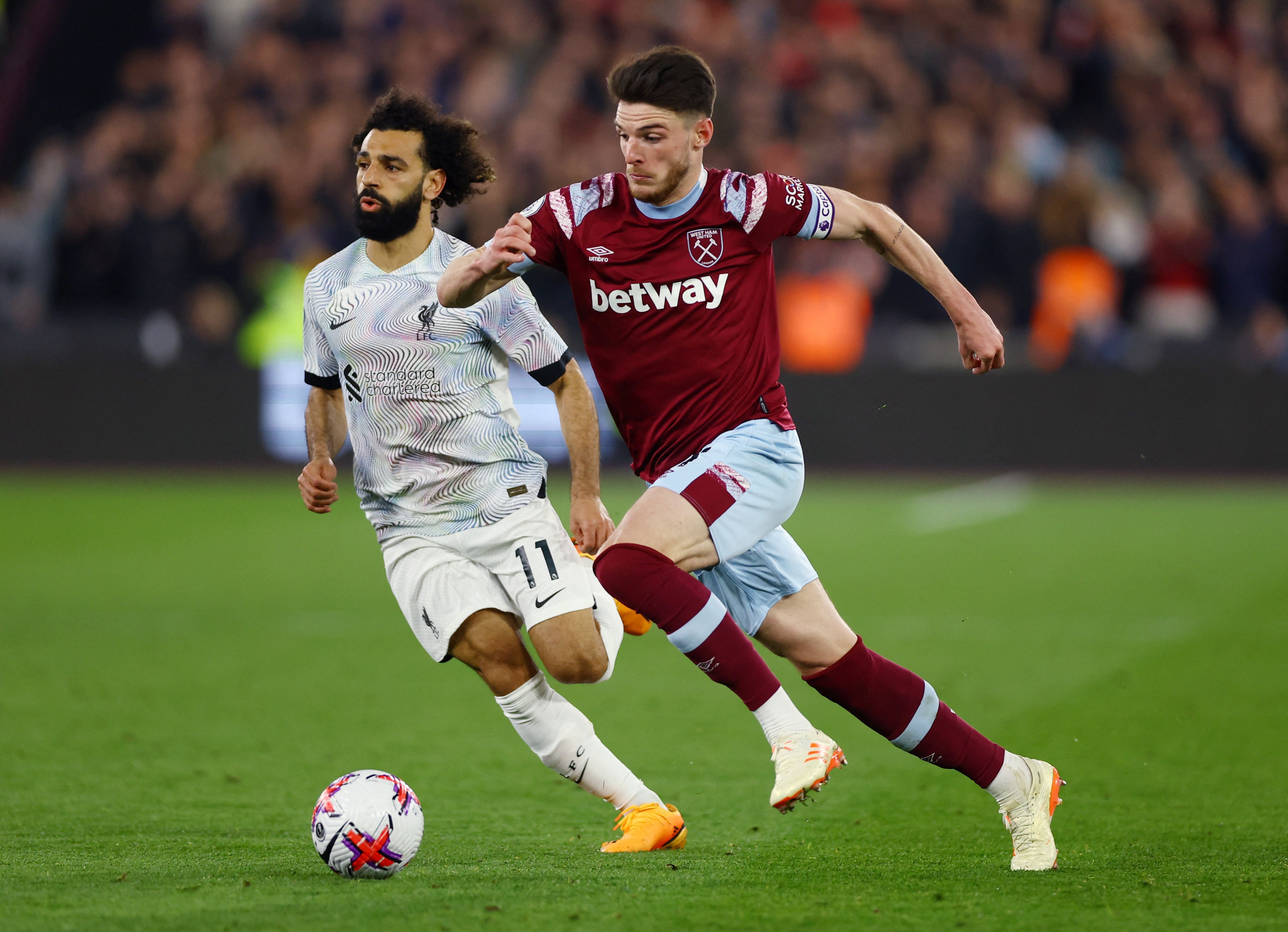 West Ham United's Declan Rice in action with Liverpool's Mohamed Salah