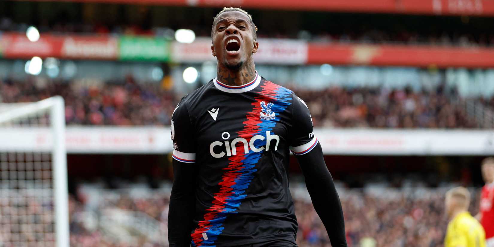 Zaha celebrates a goal