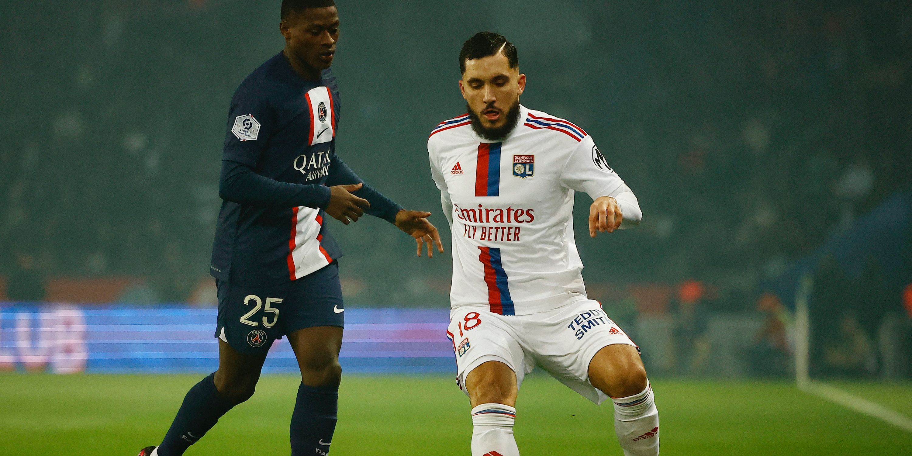 Olympique Lyonnais' Rayan Cherki in action with Paris St Germain's Nuno Mendes