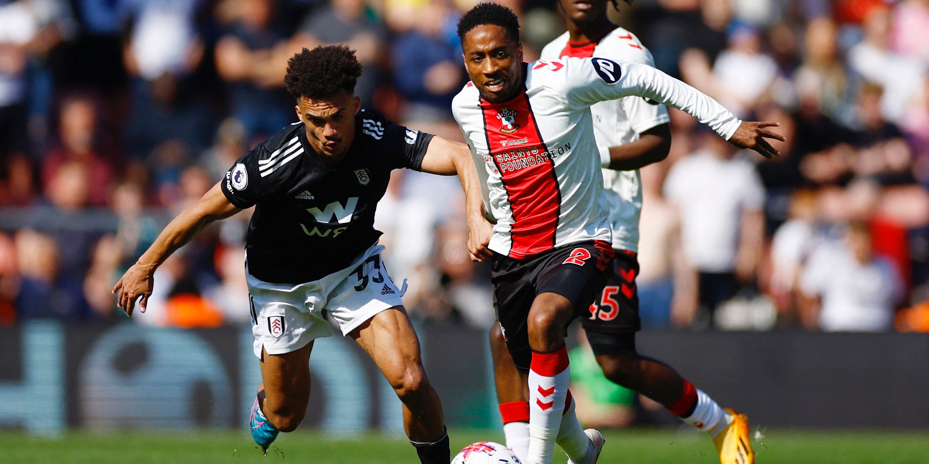 Fulham's Antonee Robinson in action with Southampton's Kyle Walker-Peters and Romeo Lavia