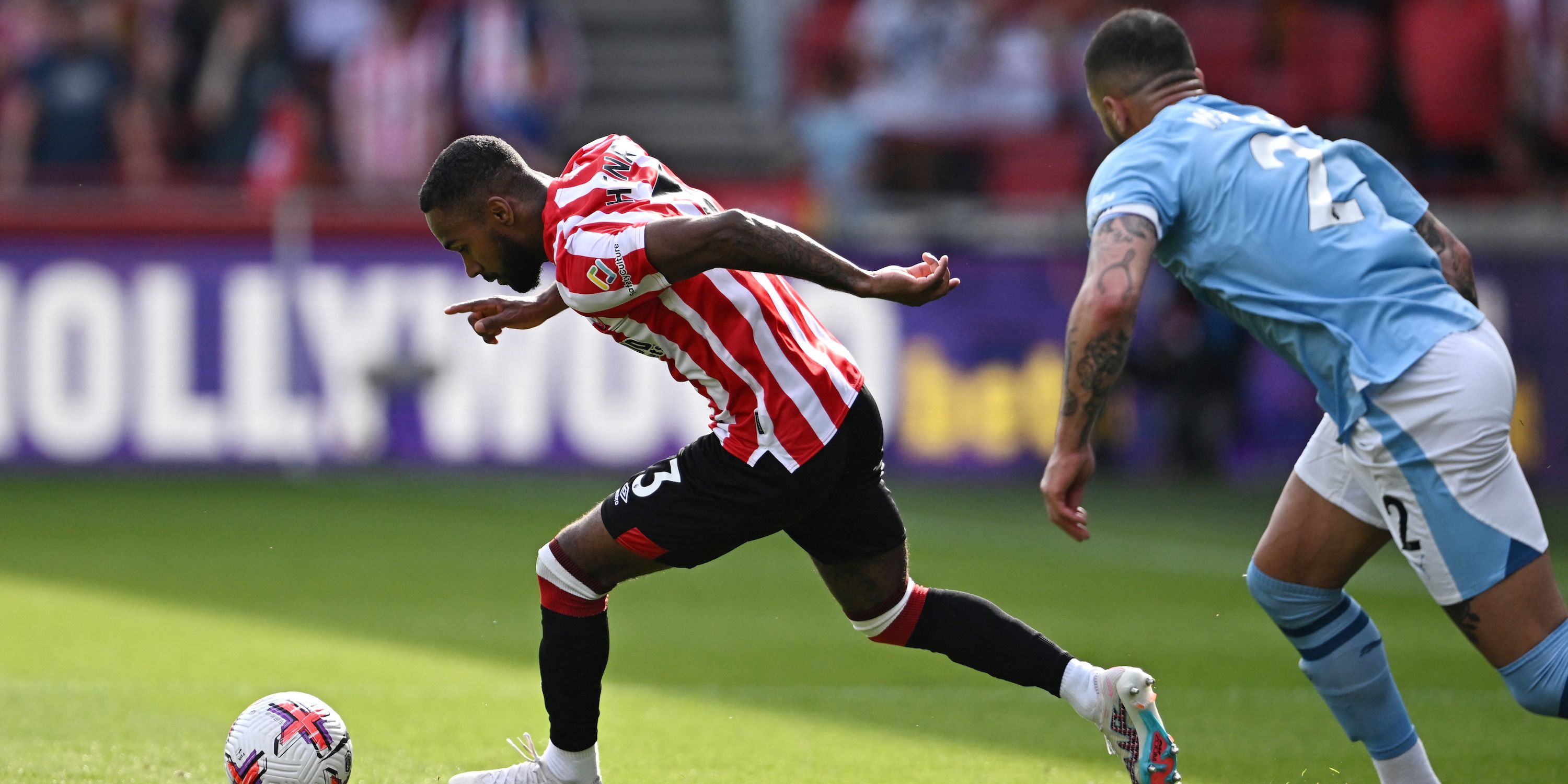 Brentford's Rico Henry in action with Manchester City's Kyle Walker 