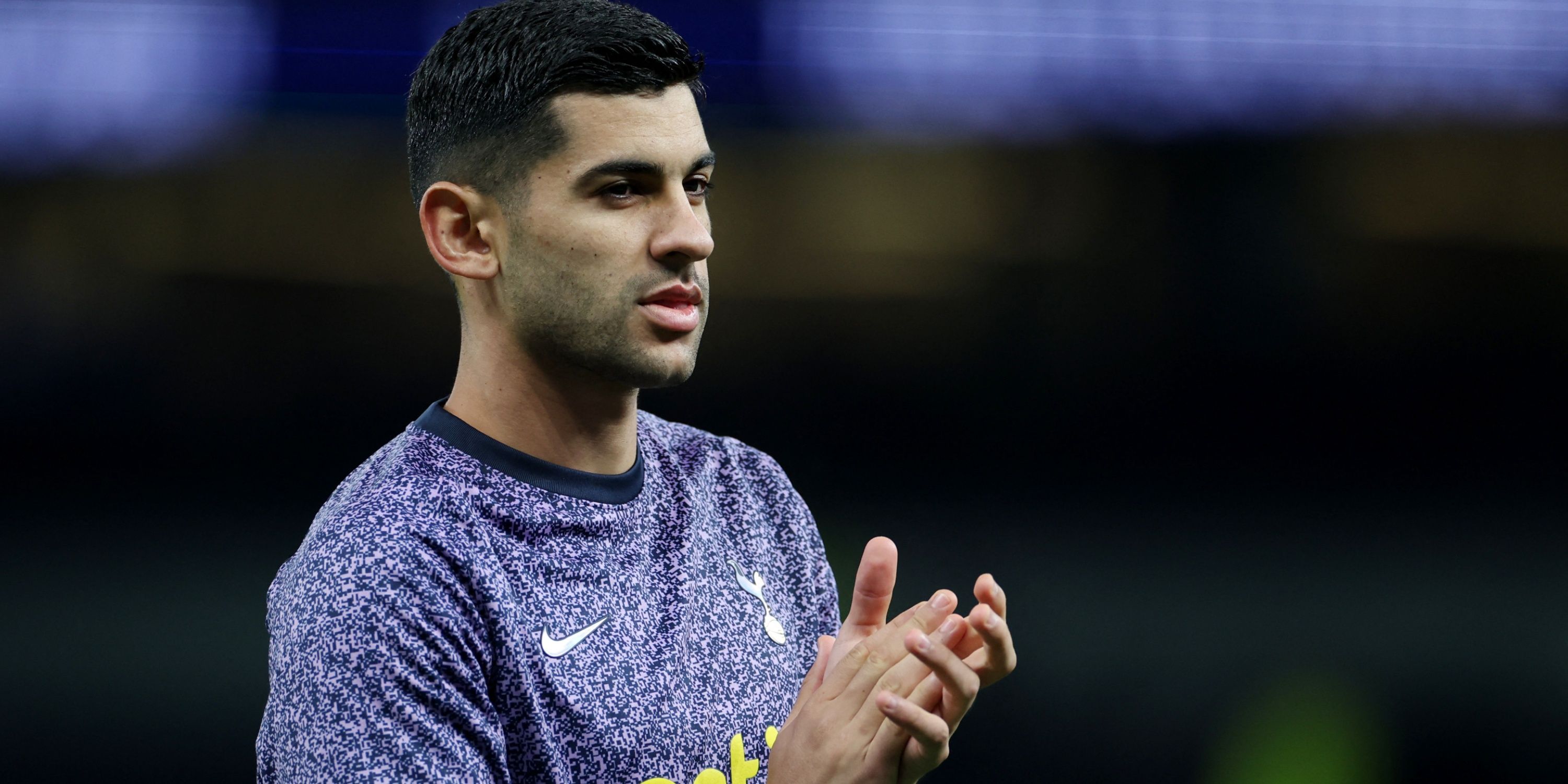 Cristian Romero warms up for Tottenham.