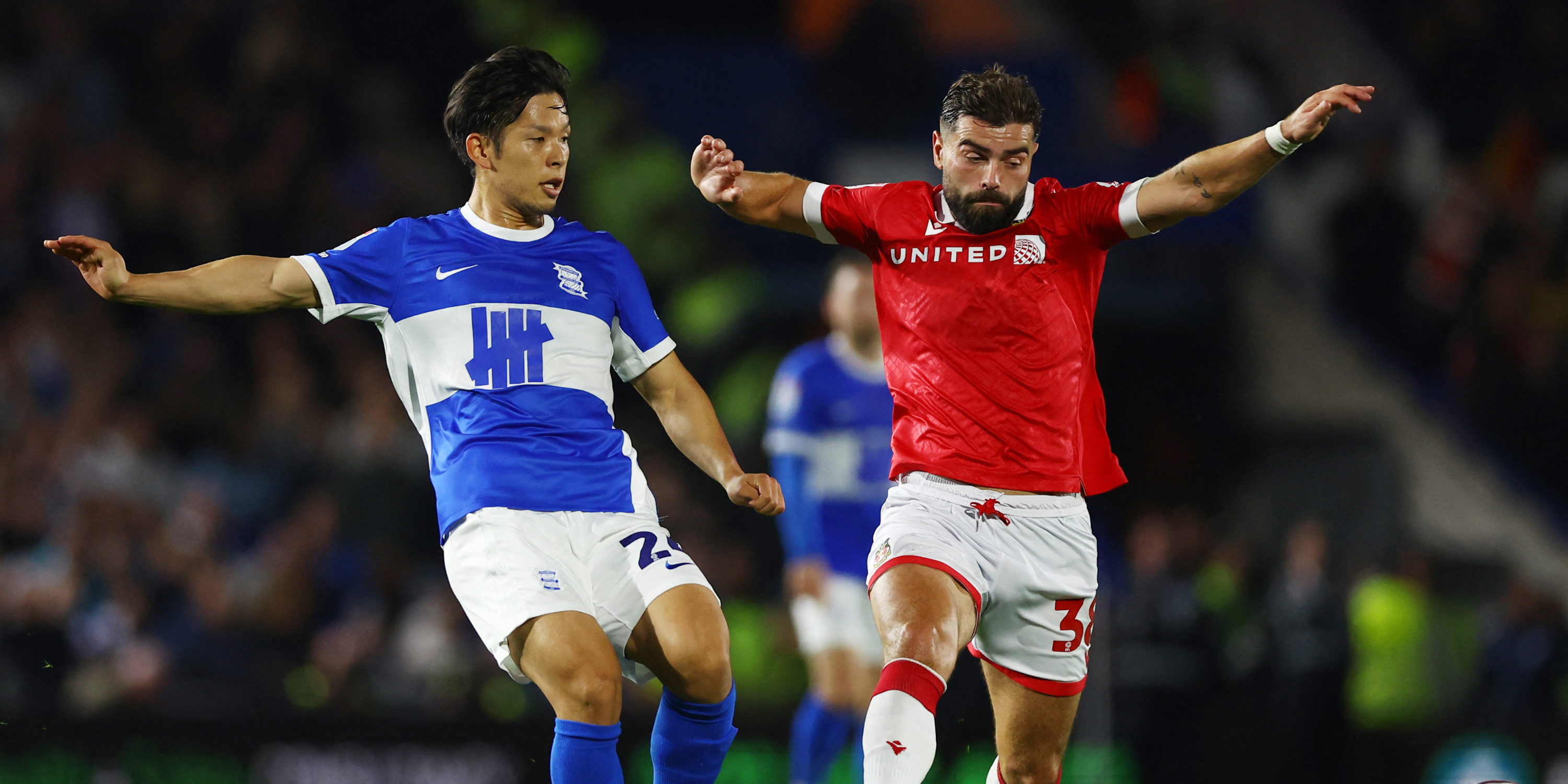 Wreham's Elliot Lee in action with Birmingham City's Tomoki Iwata.