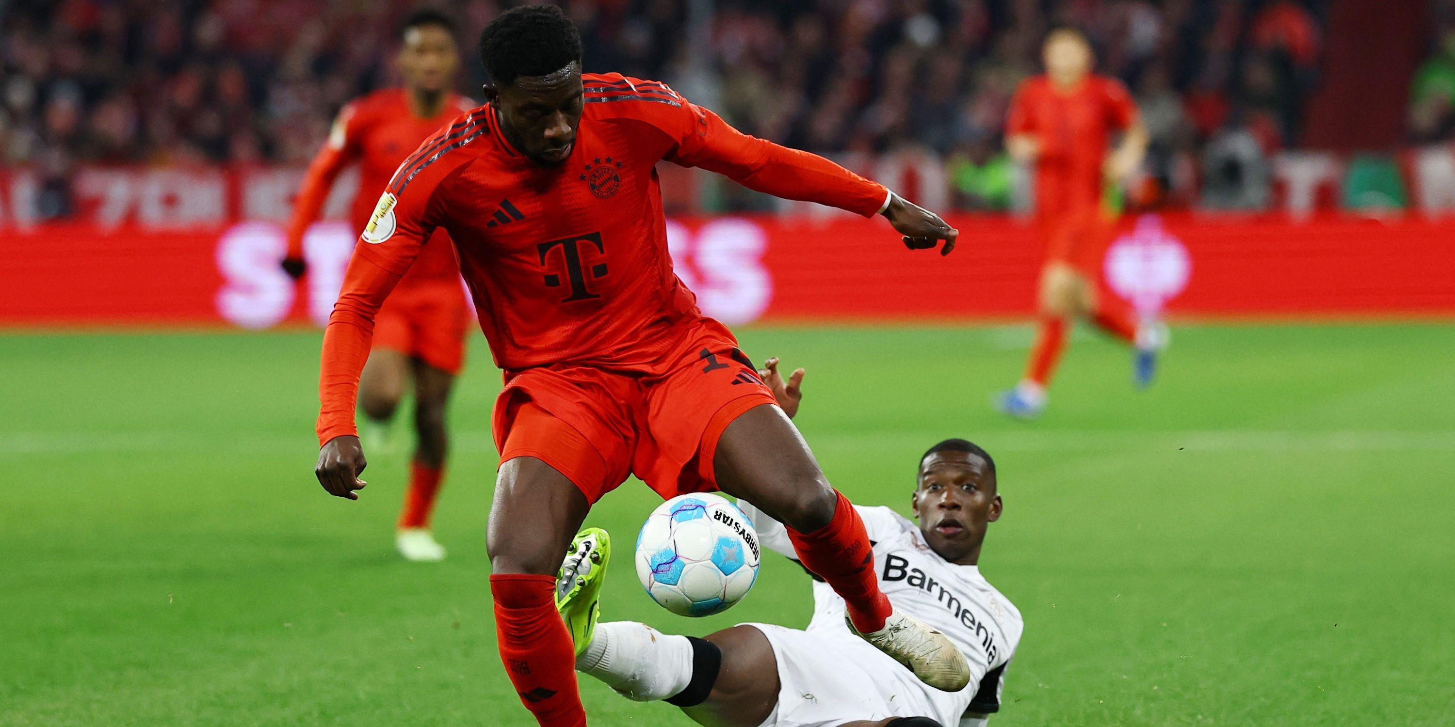 Bayern Munich's Alphonso Davies in action with Bayer Leverkusen's Nordi Mukiele