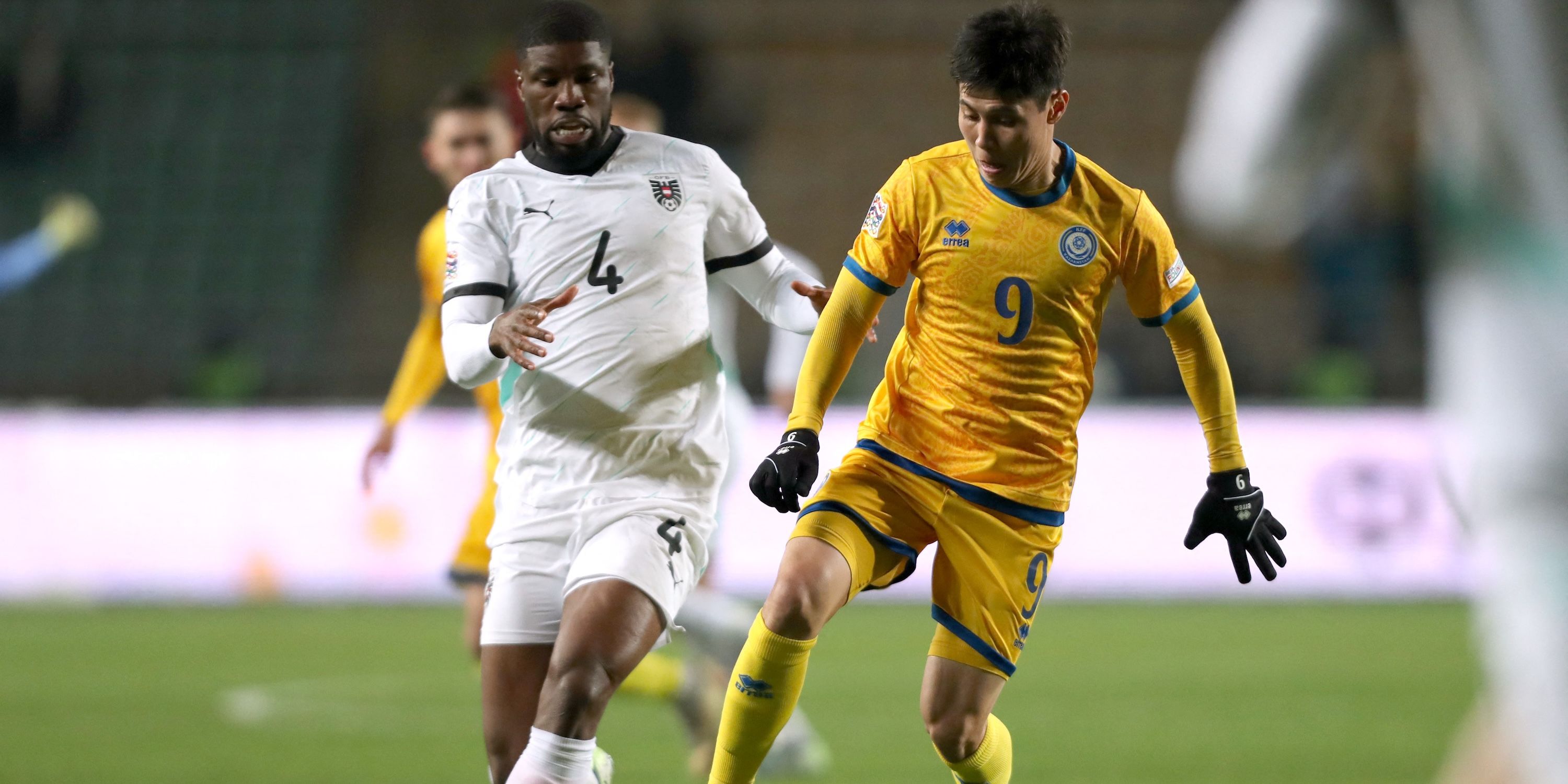 Kazakhstan's Bauyrzhan Islamkhan in action with Austria's Kevin Danso