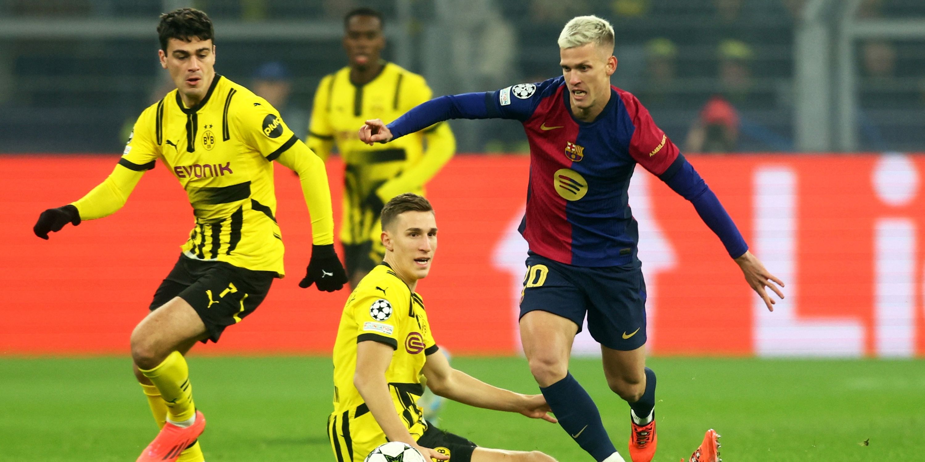 Barcelona's Dani Olmo in action with Borussia Dortmund's Giovanni Reyna and Nico Schlotterbeck