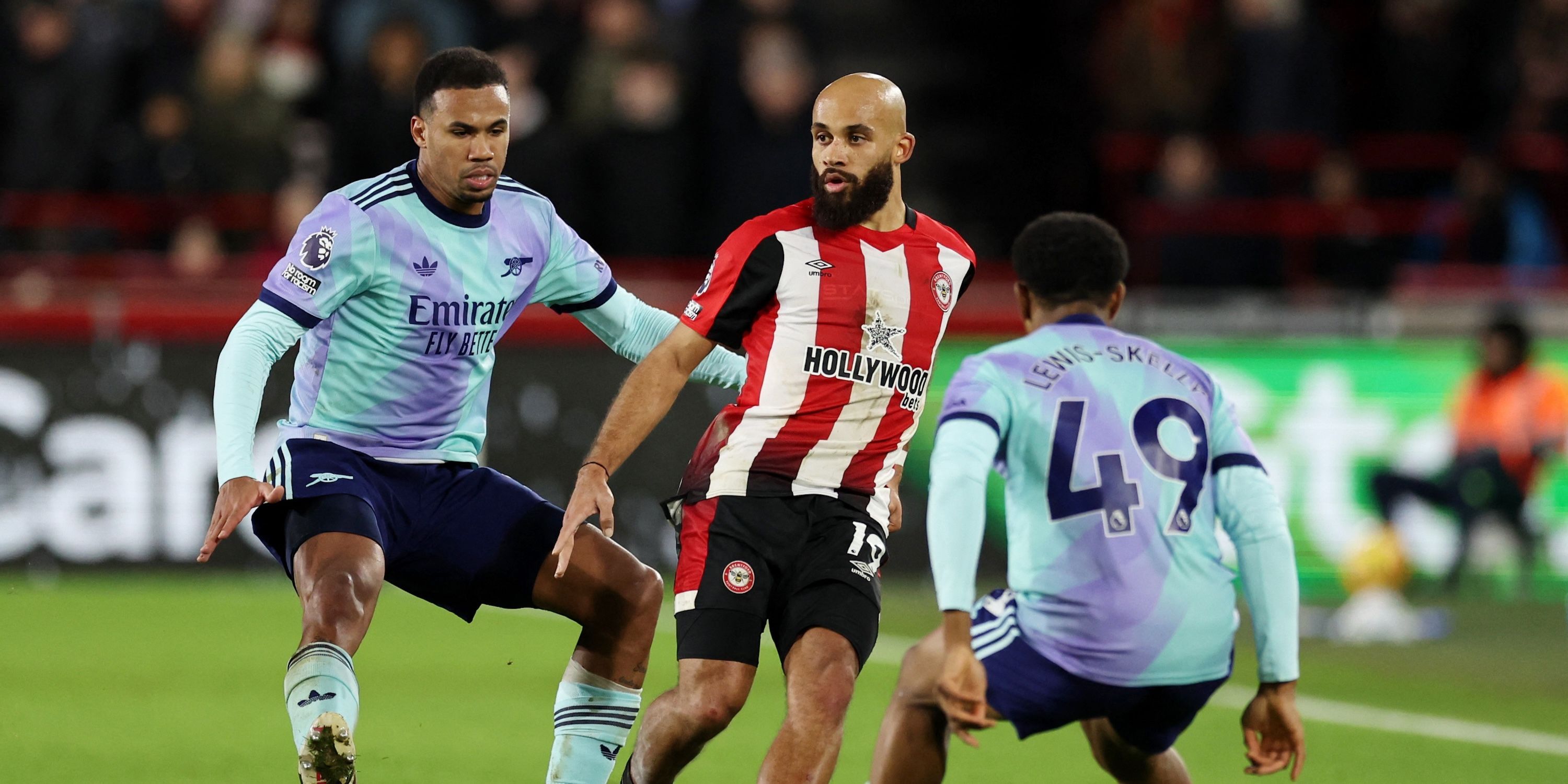 Brentford's Bryan Mbeumo in action with Arsenal's Myles Lewis-Skelly and Gabriel Magalhaes