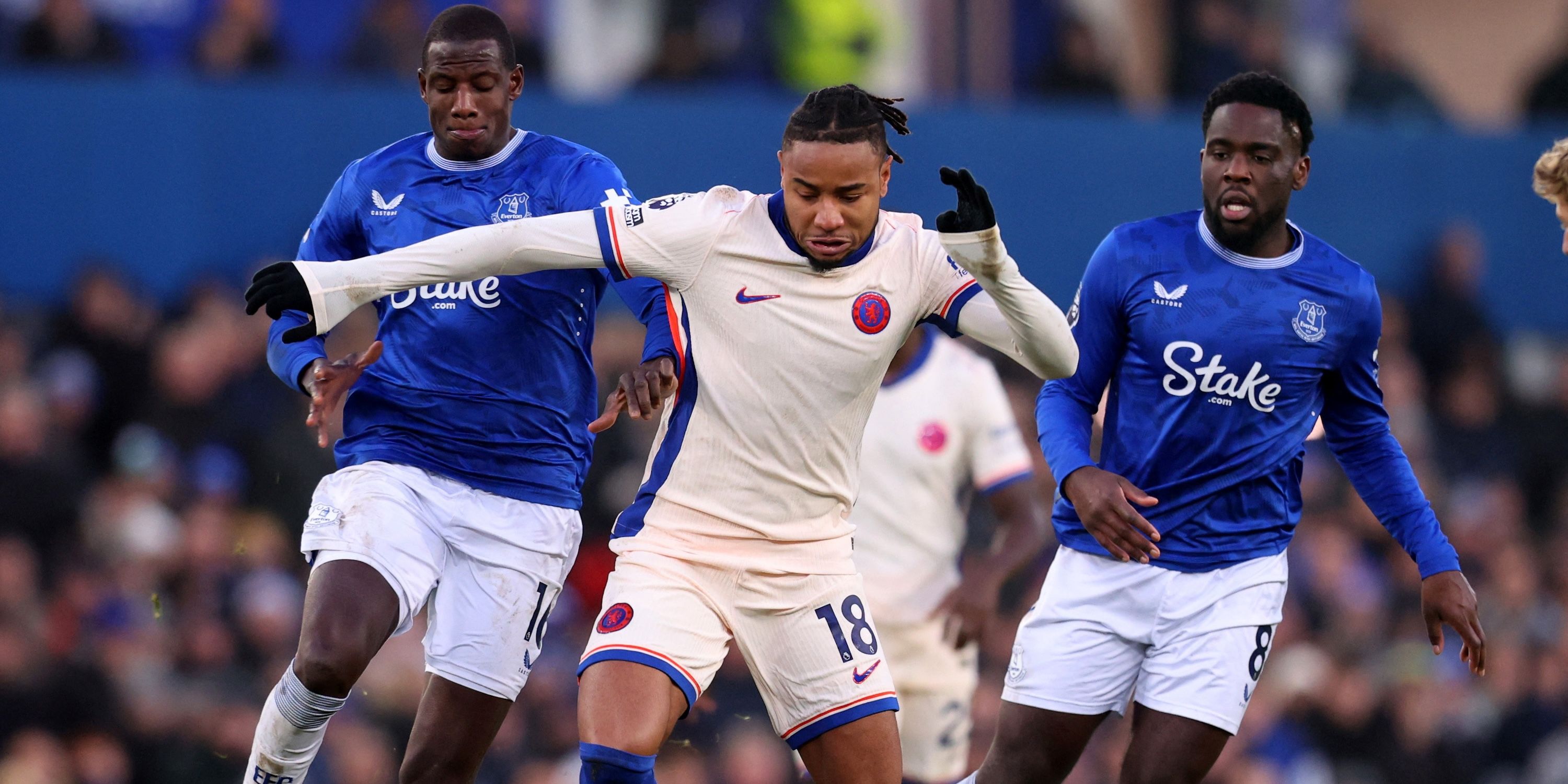 Chelsea's Christopher Nkunku in a match with Everton's Abdoulaye Doucoure and Uriel Mangala