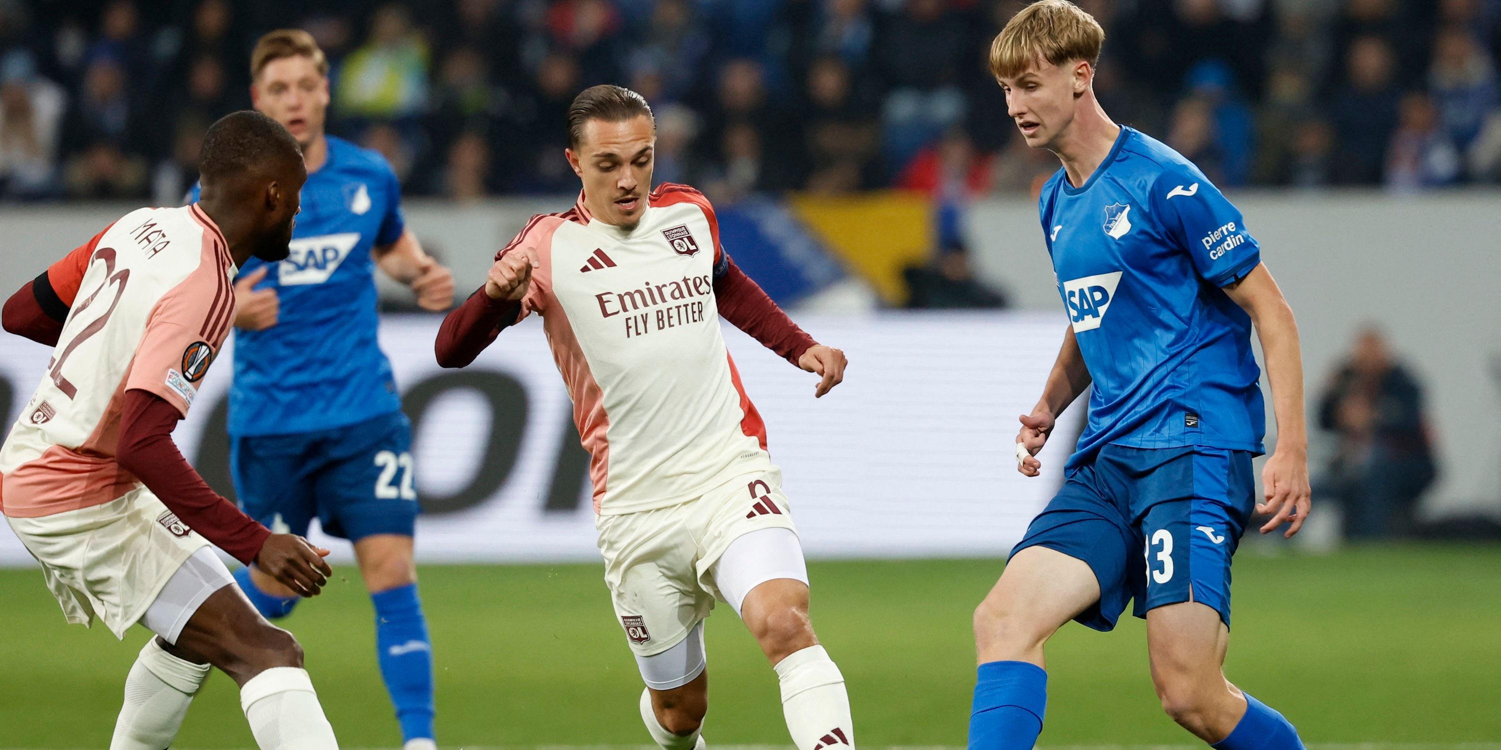 Maxence Caqueret of Olympique Lyonnais in a match with Max Morstedt of TSG 1899 Hoffenheim