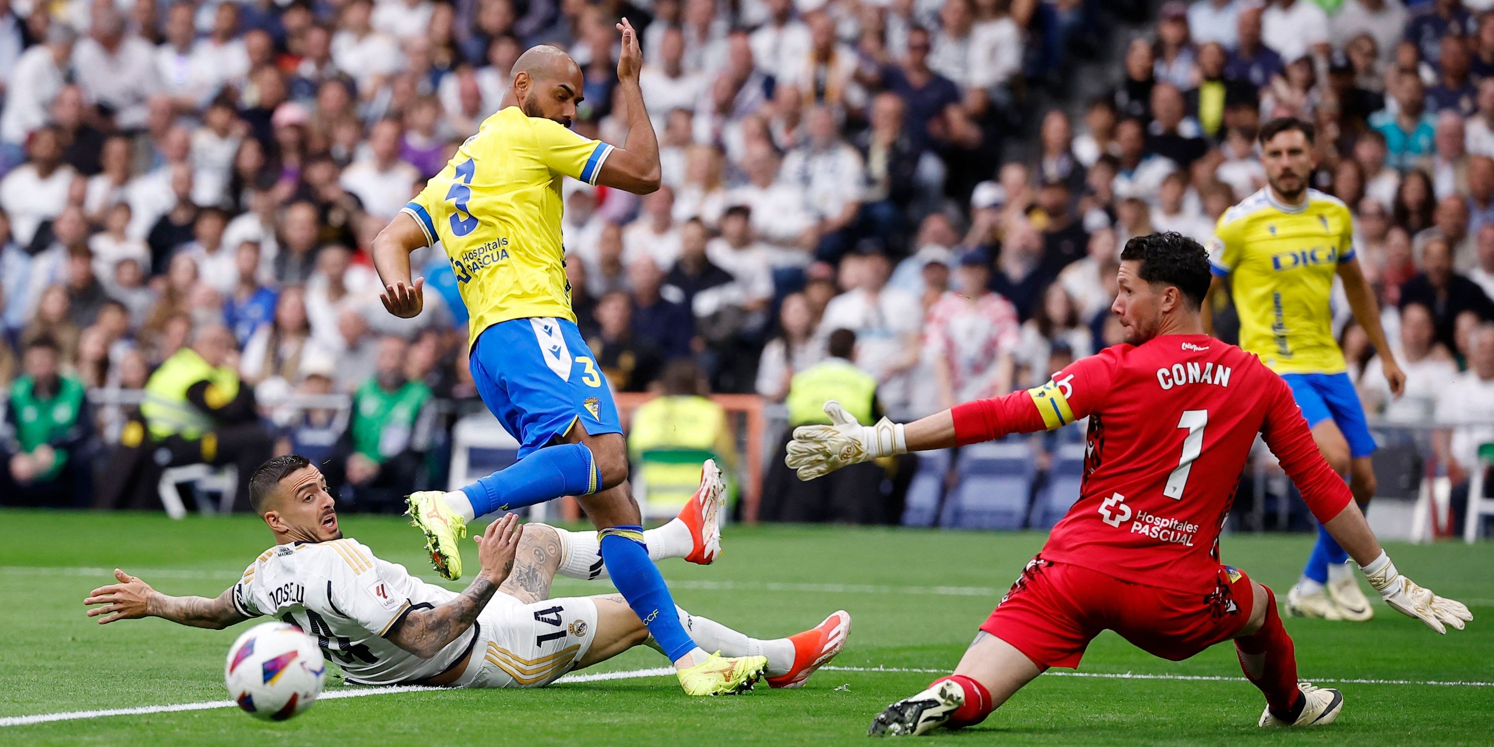 Real Madrid's Joselu in action with Cadiz's Fali and Jeremias Ledesma