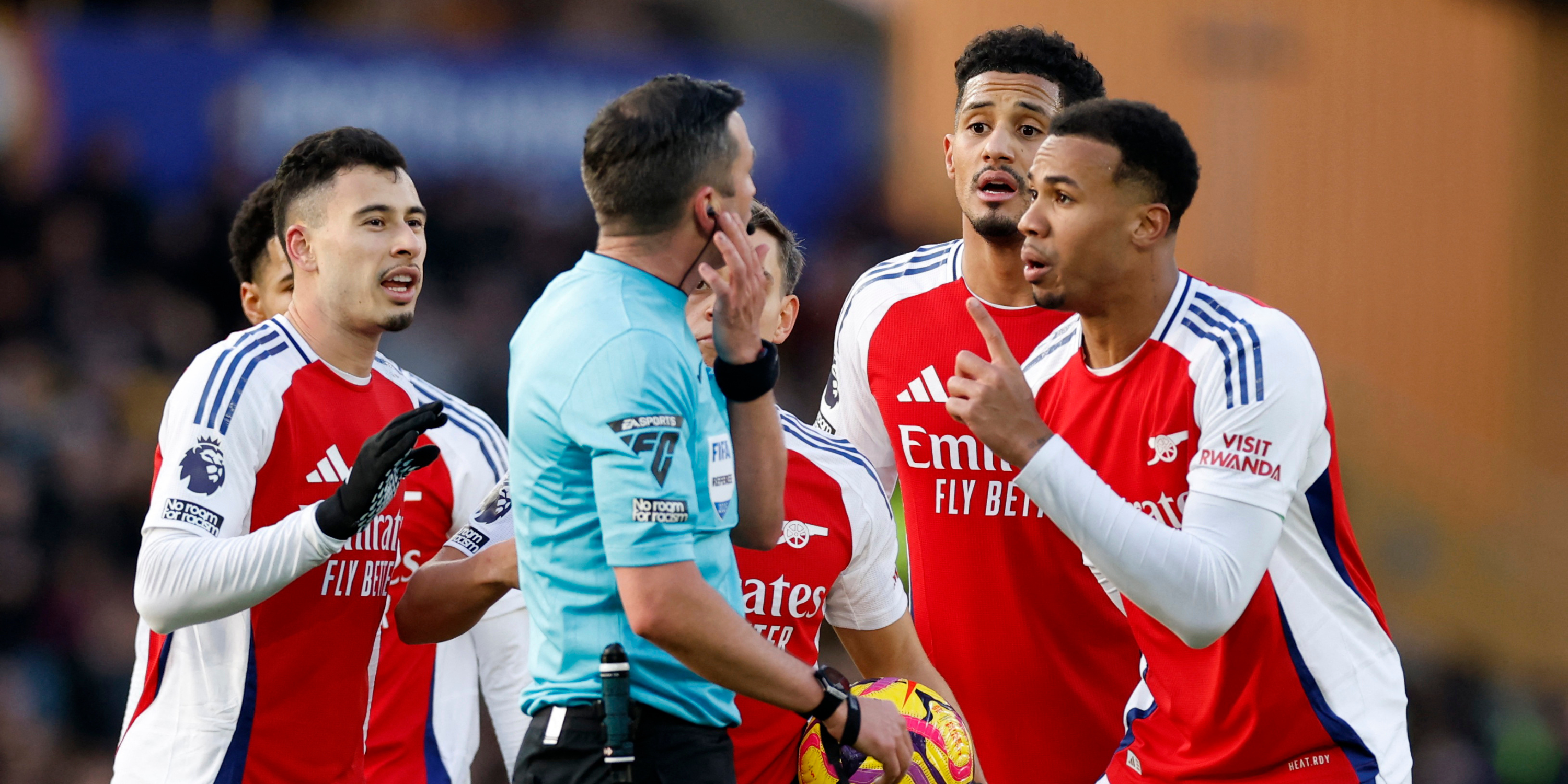 Arsenal players protest Myles Lewis-Skelly's red card versus Wolves.