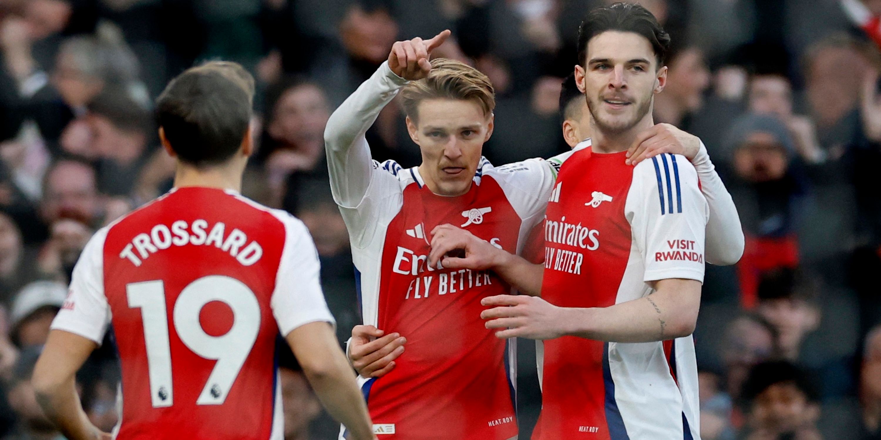 Arsenal's Martin Odegaard celebrates scoring their first goal with Declan Rice and Leandro Trossard