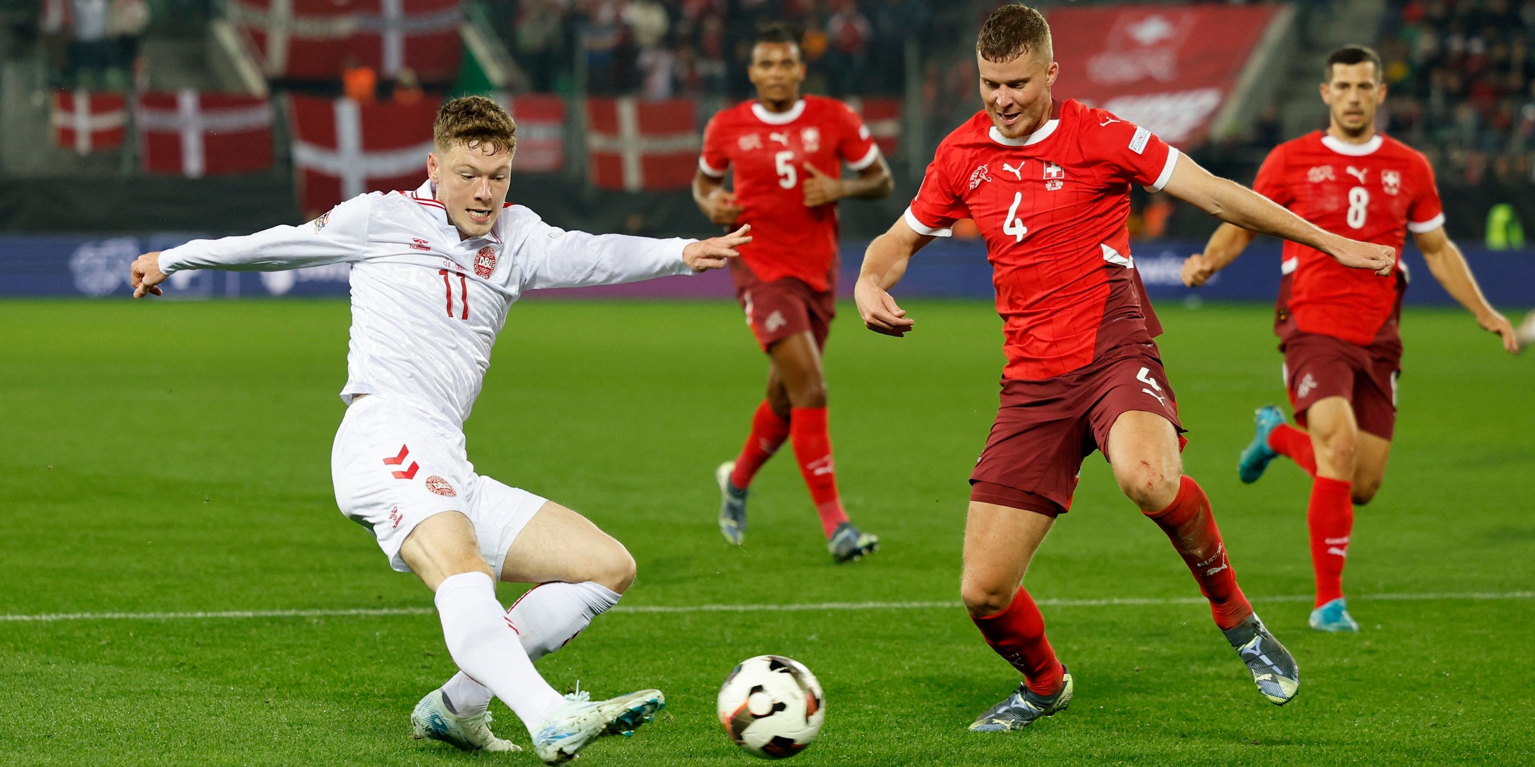 Denmark's Andreas Skov Olsen in action with Switzerland's Nico Elvedi